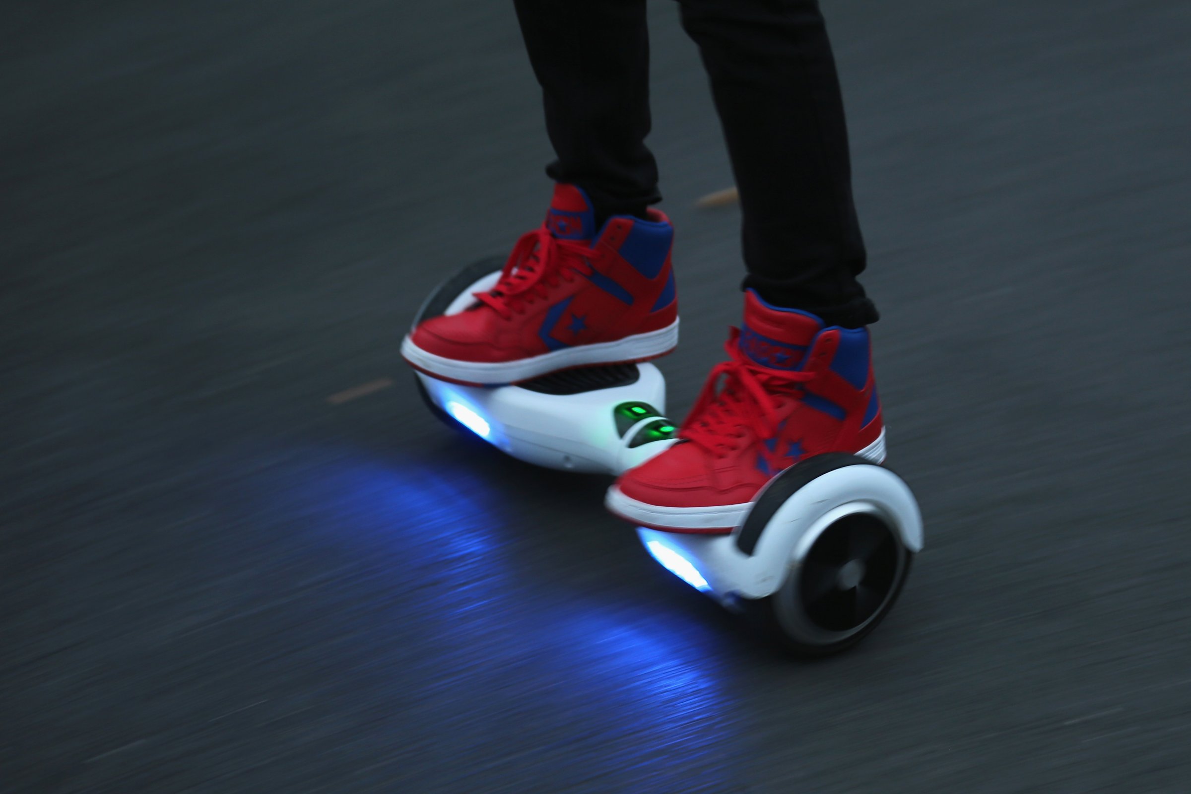 A youth poses as he rides a hoverboard, which are also known as self-balancing scooters and balance boards, on October 13, 2015 in Knutsford, England.The British Crown Prosecution Service have declared that the devices are illegal as they are are too unsafe to ride on the road, and too dangerous to ride on the pavement.