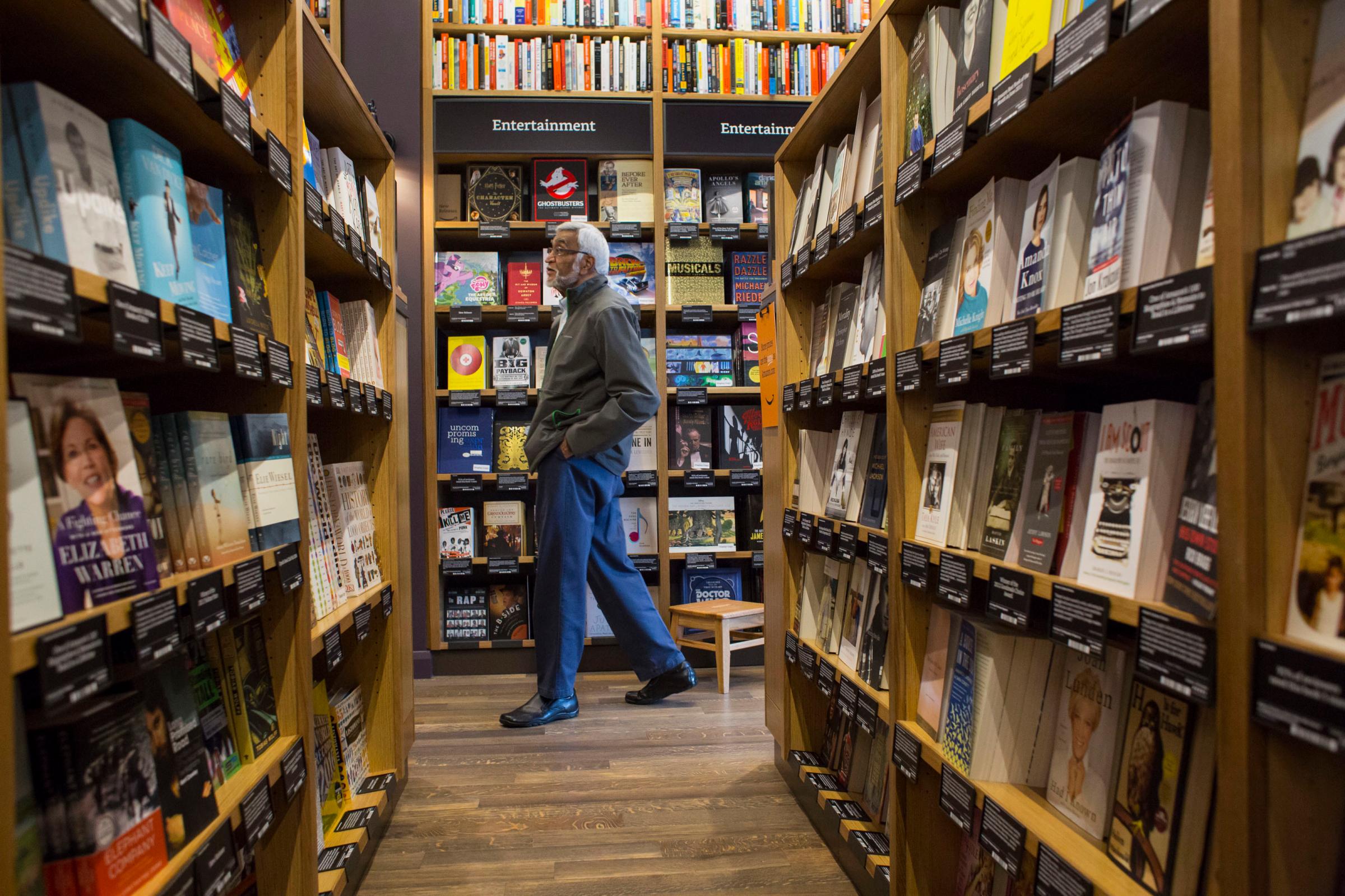 A customer shops at Amazon Books in Seattle, Washington, on Tuesday, Nov. 3, 2015. The online retailer Amazon.com Inc. opened its first brick-and-mortar location in Seattle's upscale University Village mall. Photographer: David Ryder/Bloomberg