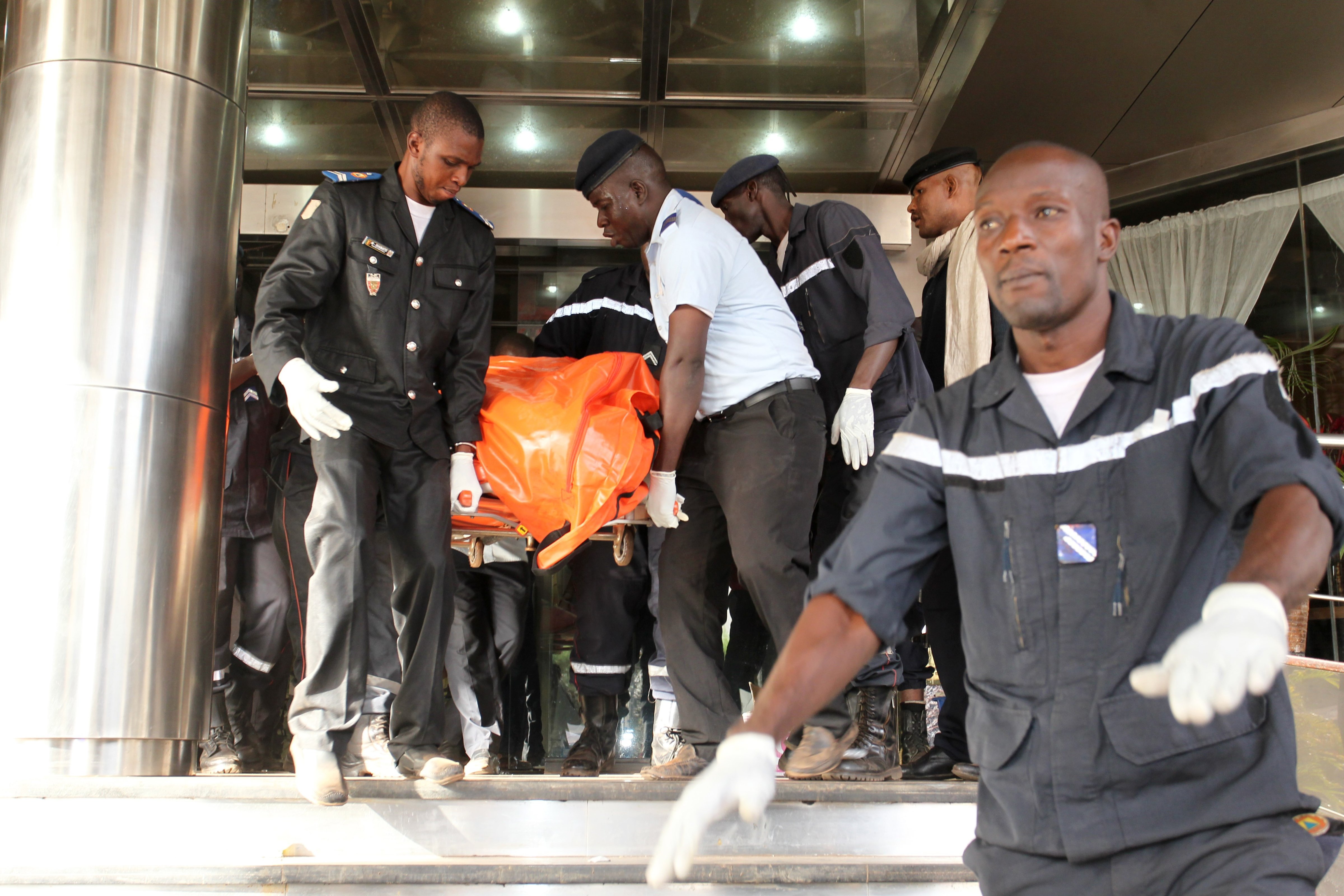 Officers evacuate bodies of victims from the Radisson Blu Hotel in Bamako, Mali,  on Nov. 20, 2015, where at least 19 people, including 3 Chinese executives, died (Habibou Kouyate—AFP/Getty Images)