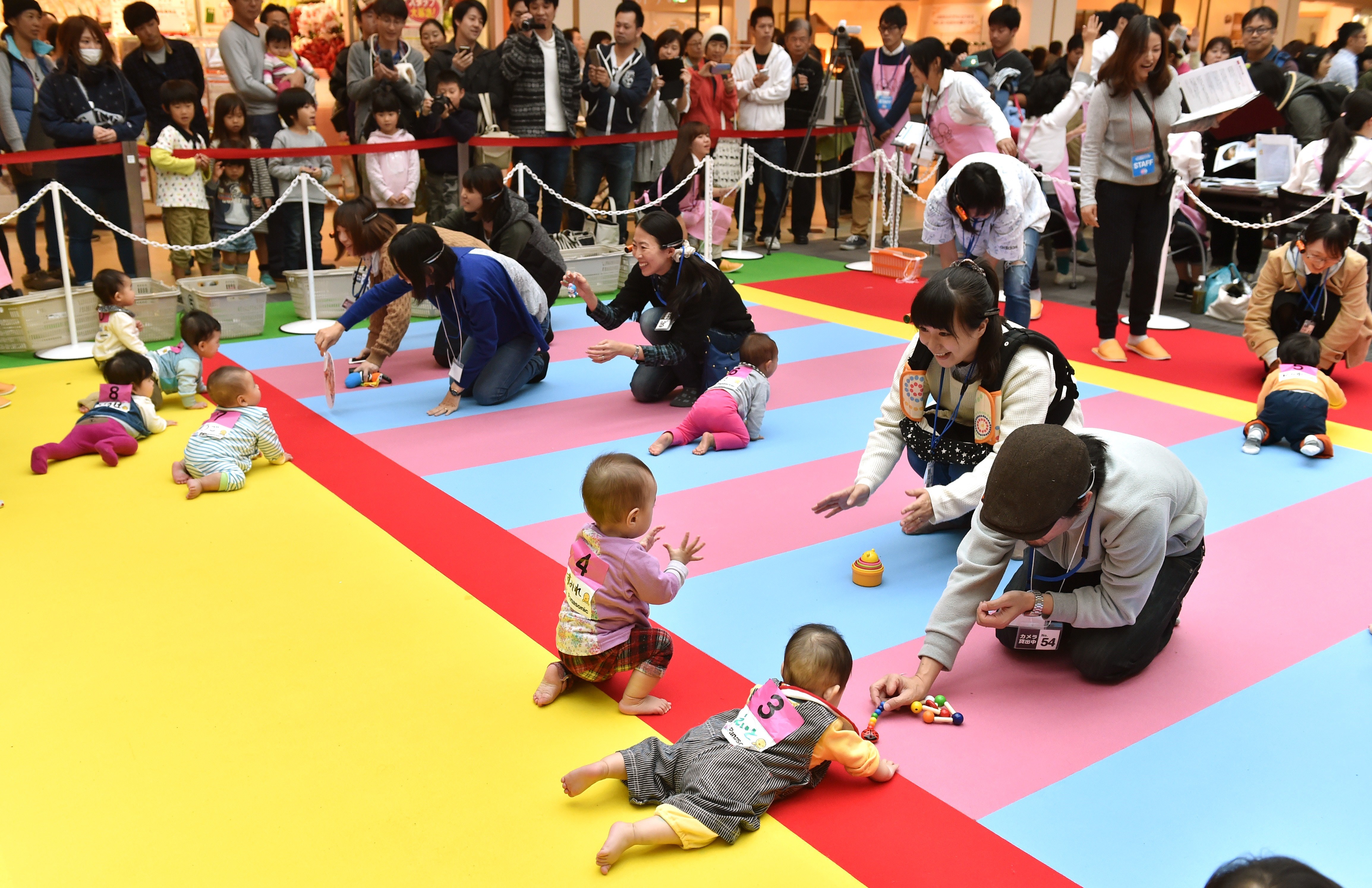 Babies compete in a baby crawling competition hosted by a Japanese magazine that specializes in pregnancy, childbirth and child-rearing, in Yokohama, Kanagawa on Nov. 23, 2015. (Kazuhiro Nogi—AFP/Getty Images)