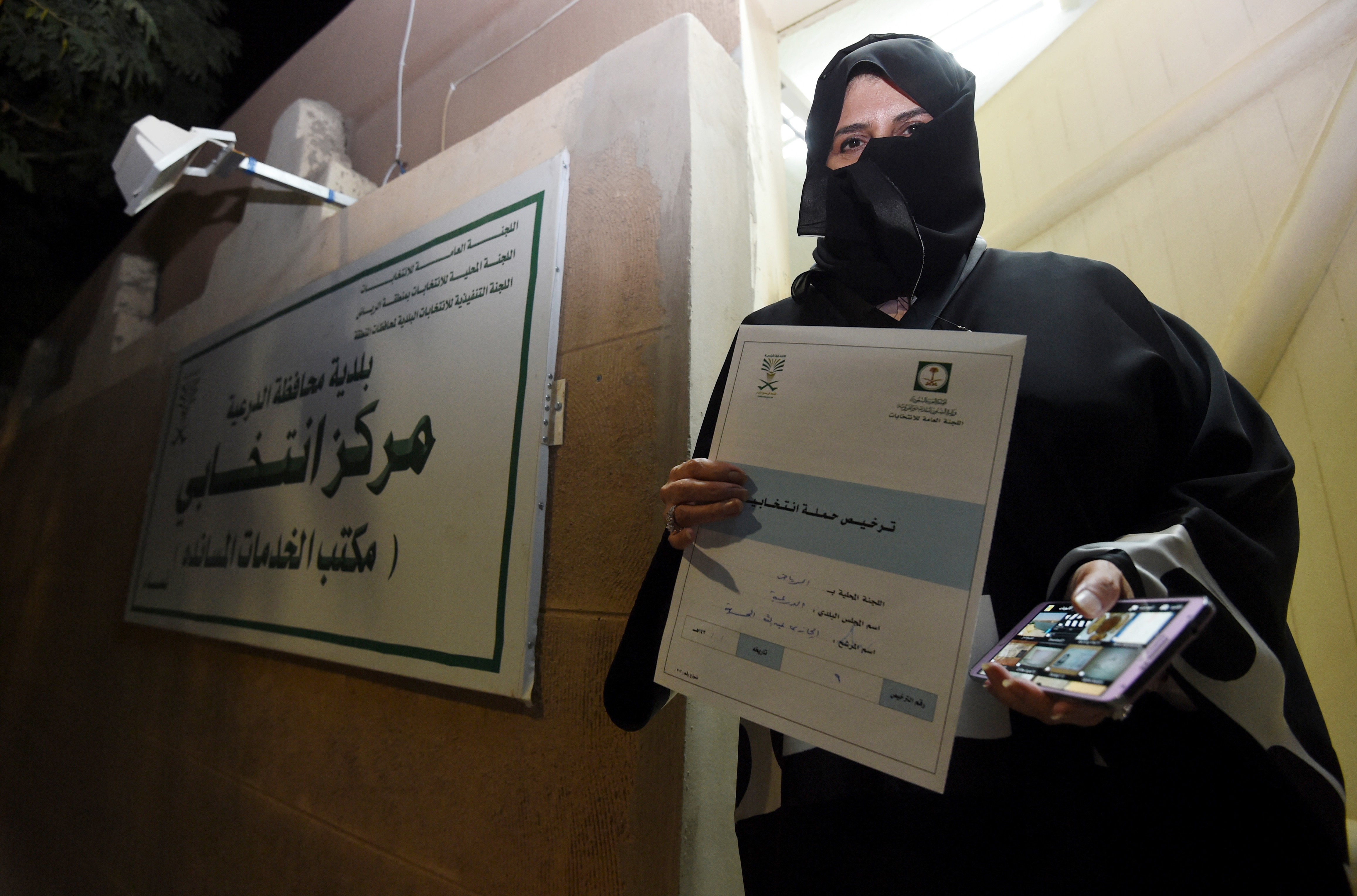 Aljazi al-Hussaini, a candidate for the municipal council in the town of Diriyah, on the outskirts of the Saudi capital Riyadh, shows an electoral campaign license issued by the central municipal elections committee on November 29, 2015. (FAYEZ NURELDINE&mdash;AFP/Getty Images)