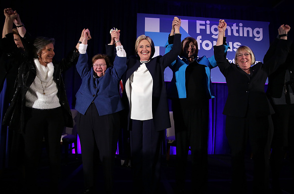 Democratic presidential candidate Hillary Clinton (3rd L) holds up hands with (L-R) Sens. Barbara Boxer (D-CA), Barbara Mikulski (D-MD), and Patty Murray (D-WA) during a 'Women for Hillary' fundraiser November 30, 2015 in Washington, DC.
