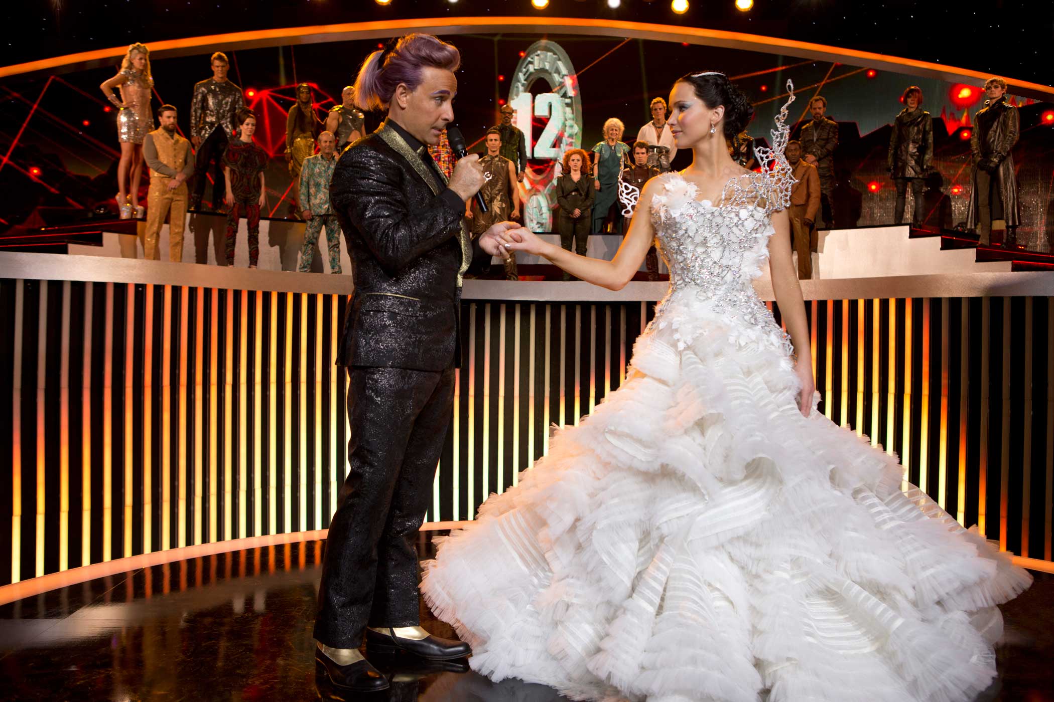 Stanley Tucci as Caesar Flickerman and Jennifer Lawrence as Katniss Everdeen in The Hunger Games: Catching Fire, 2013.