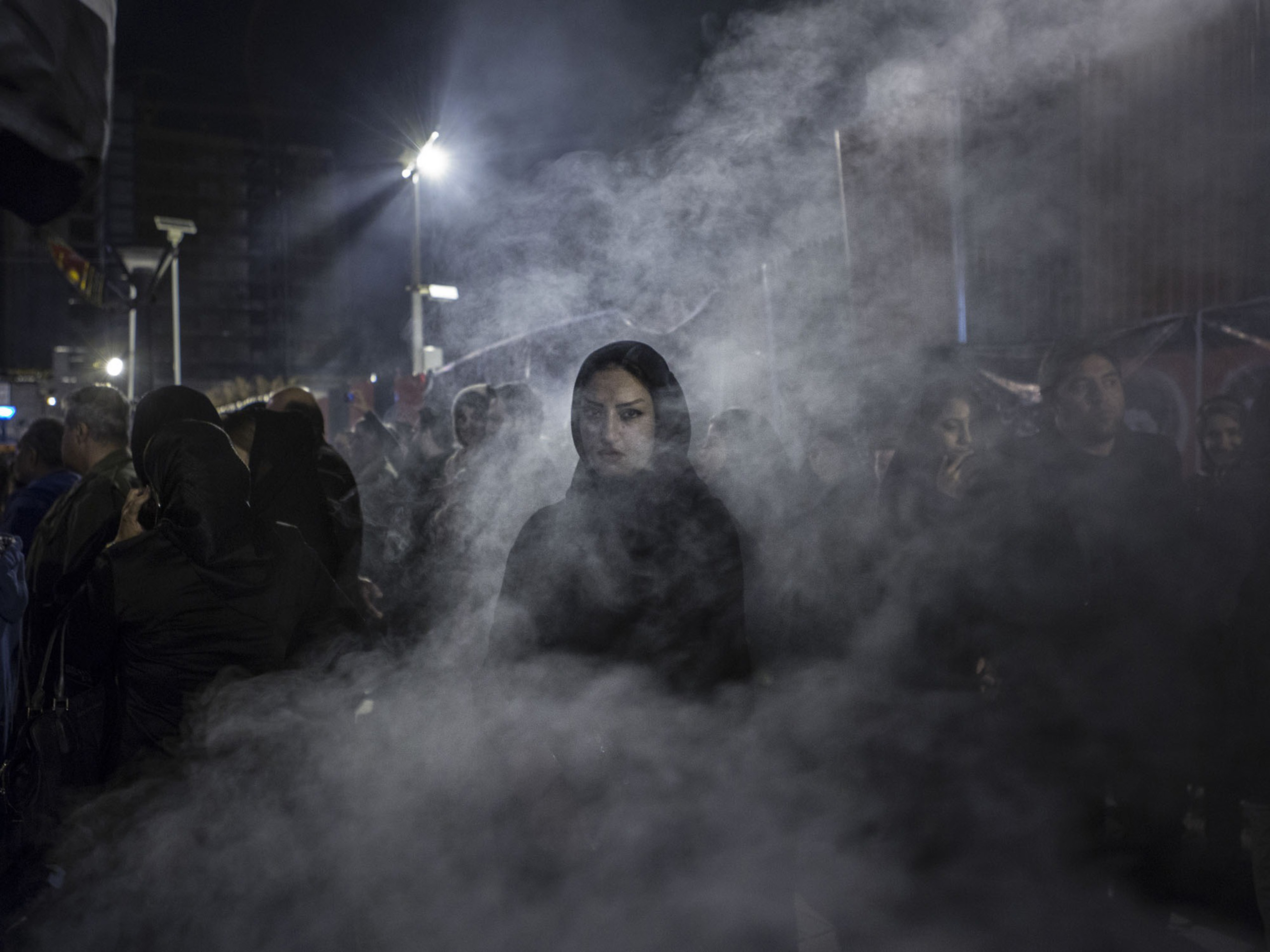 A woman in Tehran wreathed by the smoke of an herb burned during festivities marking the death of Hussein, the third Shi‘ite imam. (Newsha Tavakolian—Magnum for TIME)