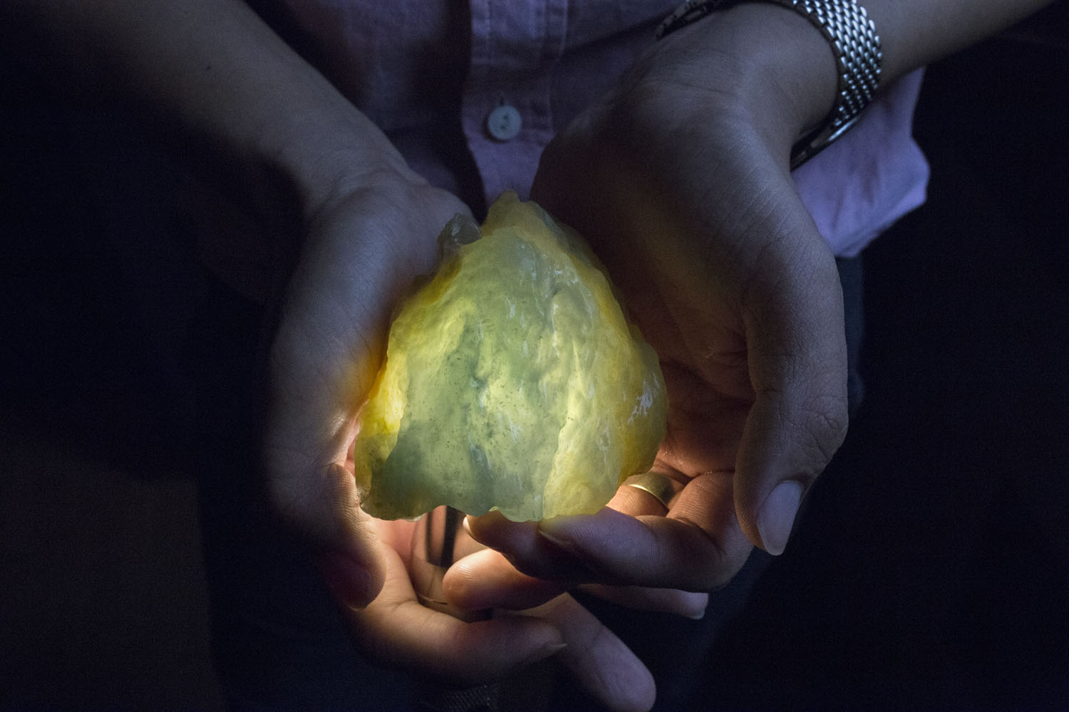 A trader shows a jade stone which he estimates to be worth at least forty or fifty thousands U.S. Dollars in price in the black market, at a hotel room in Yin Jiang, China, June 17, 2015. According to the Myanmar jade traders of the black market, almost all the raw jade stones which are being traded in Yin Jiang are smuggled directly from the black market in Myanmar's land of jade in Kachin state where the billion-dollar industry is based in.Credit : Minzayar - NRGI