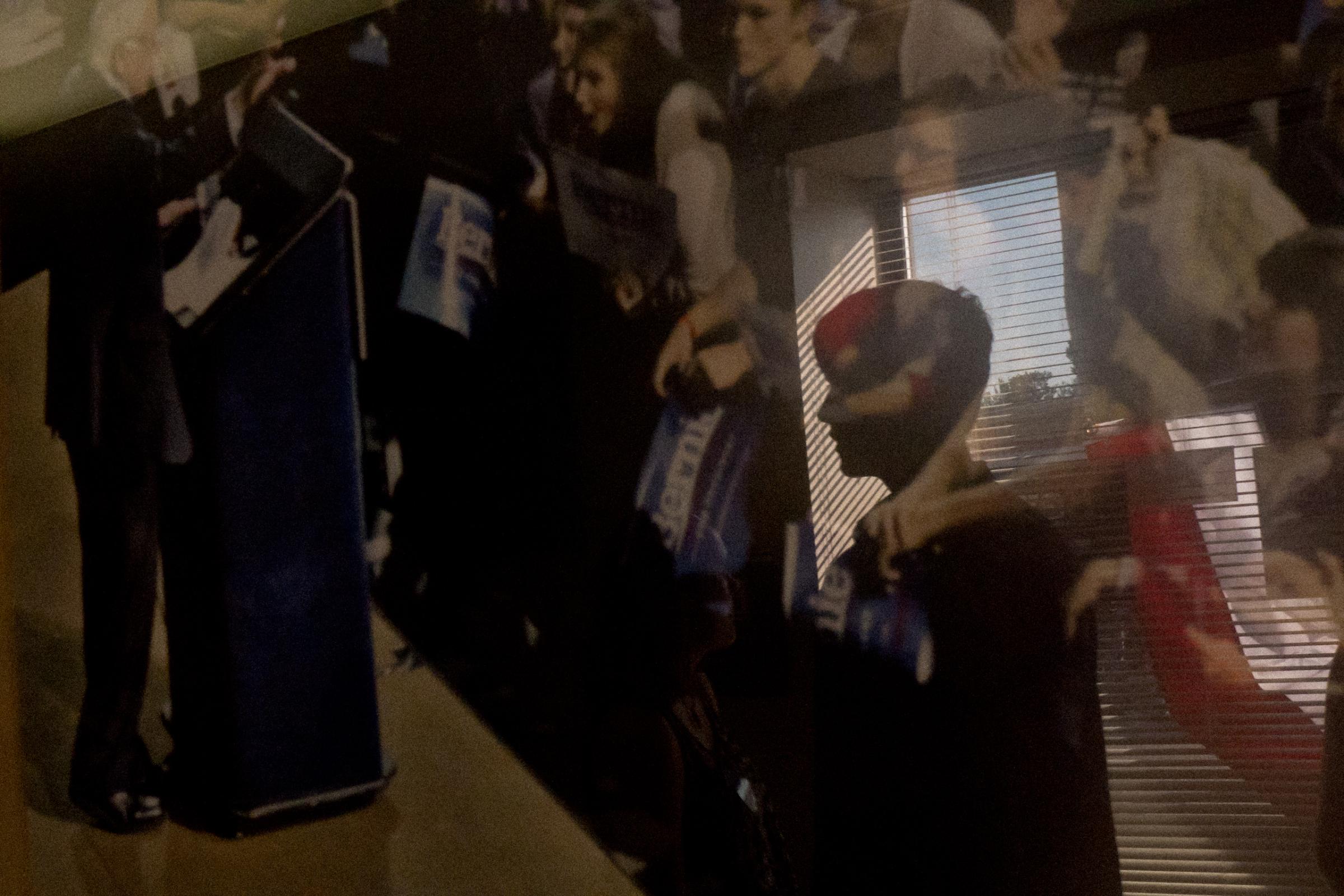 Boy reflected in photograph of Bernie Sanders at his campaign office, Concord, NH 2015.
