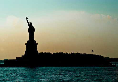 Statue of Liberty silhouetted at dawn