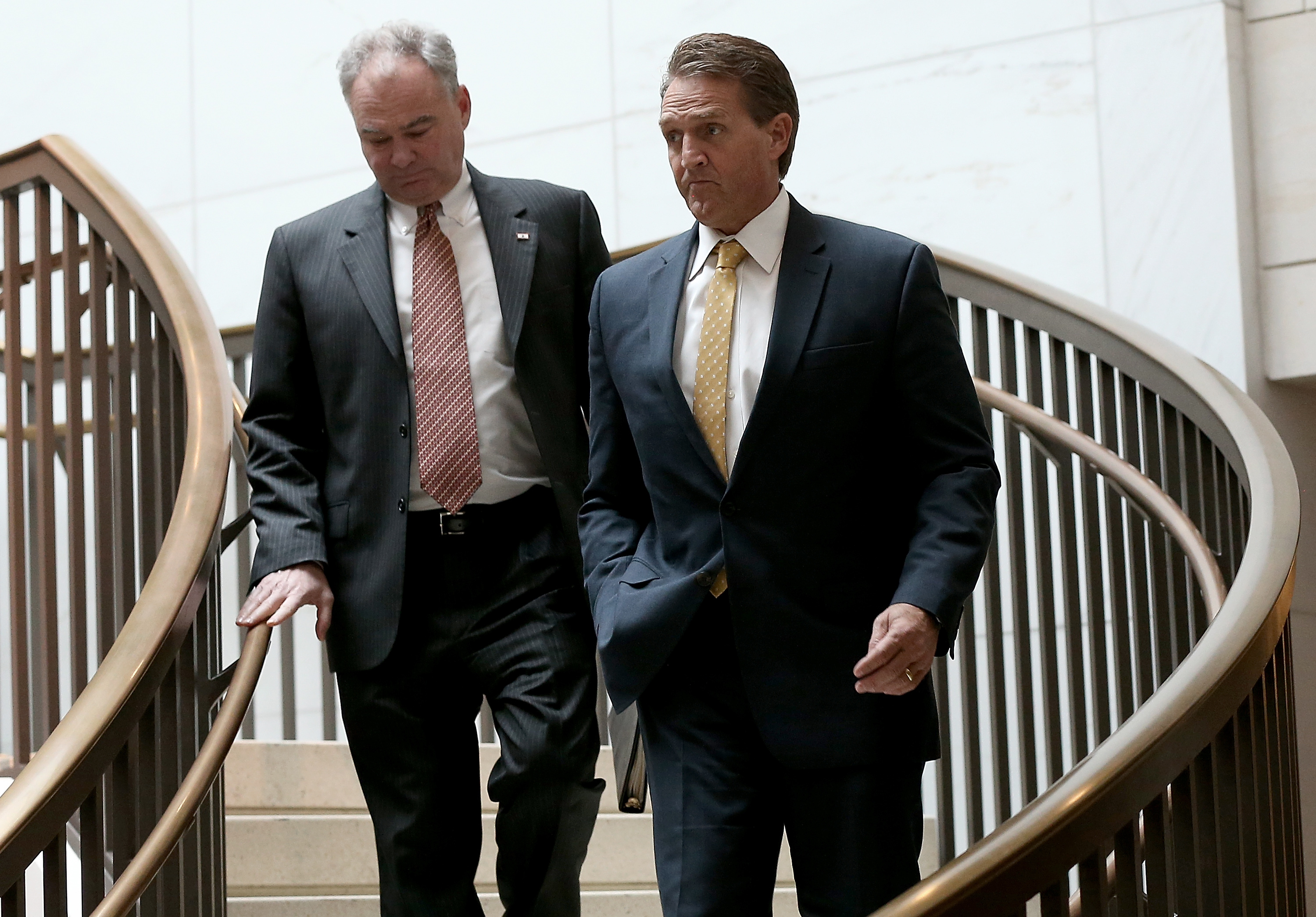 Sen. Jeff Flake (R) (R-AZ) and Sen. Tim Kaine (L) (D-VA) walk to a closed briefing at the U.S. Capitol on Nov. 10, 2015.