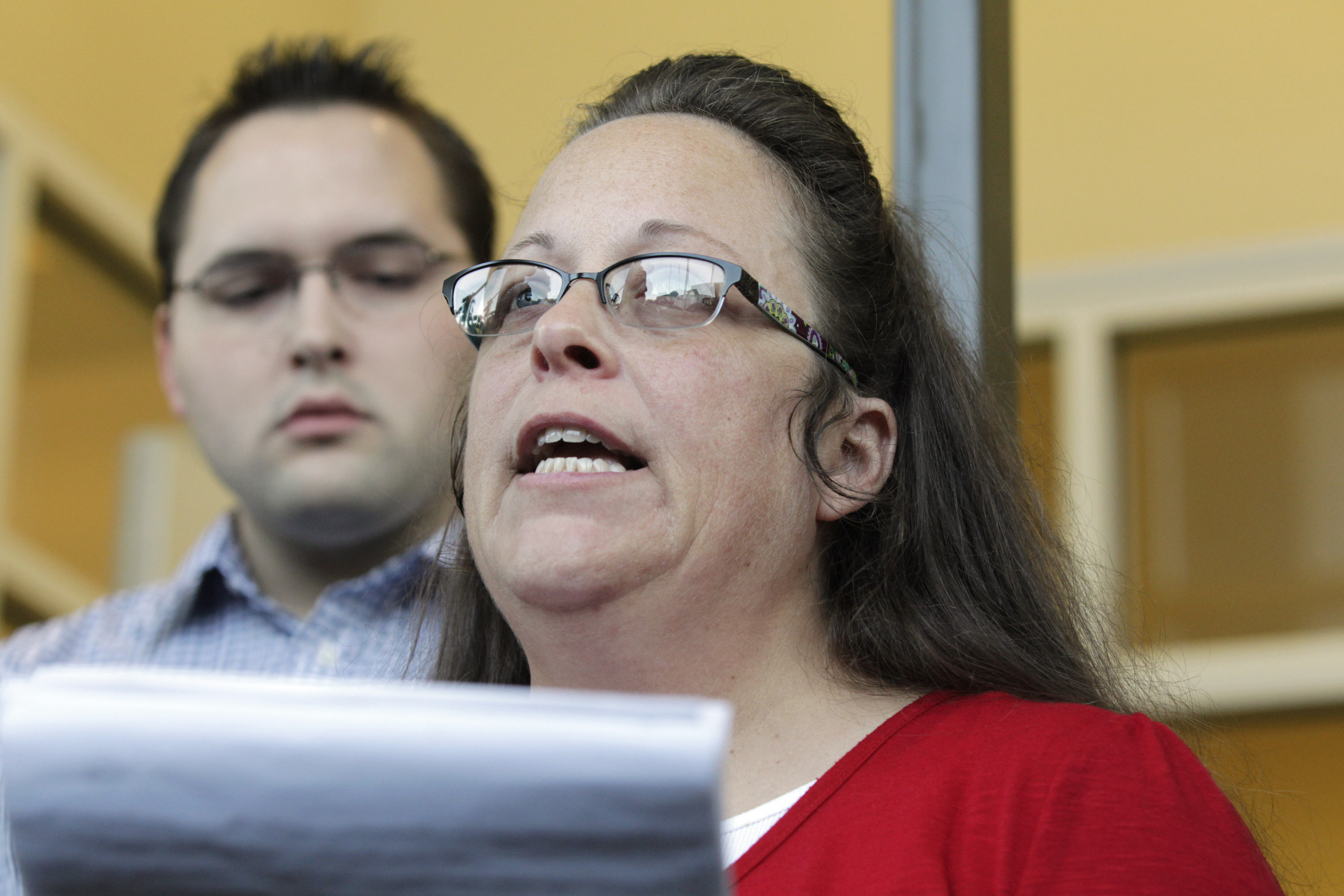 Rowan County Clerk Kim Davis, with son Nathan Davis, a deputy clerk, reads a statement to the press outside the Rowan County Courthouse on Sept. 14, 2015 in Morehead, Ky. (Pablo Alcala/Lexington Herald--Leader/TNSGetty Images) (Lexington Herald-Leader&mdash;TNS via Getty Images)