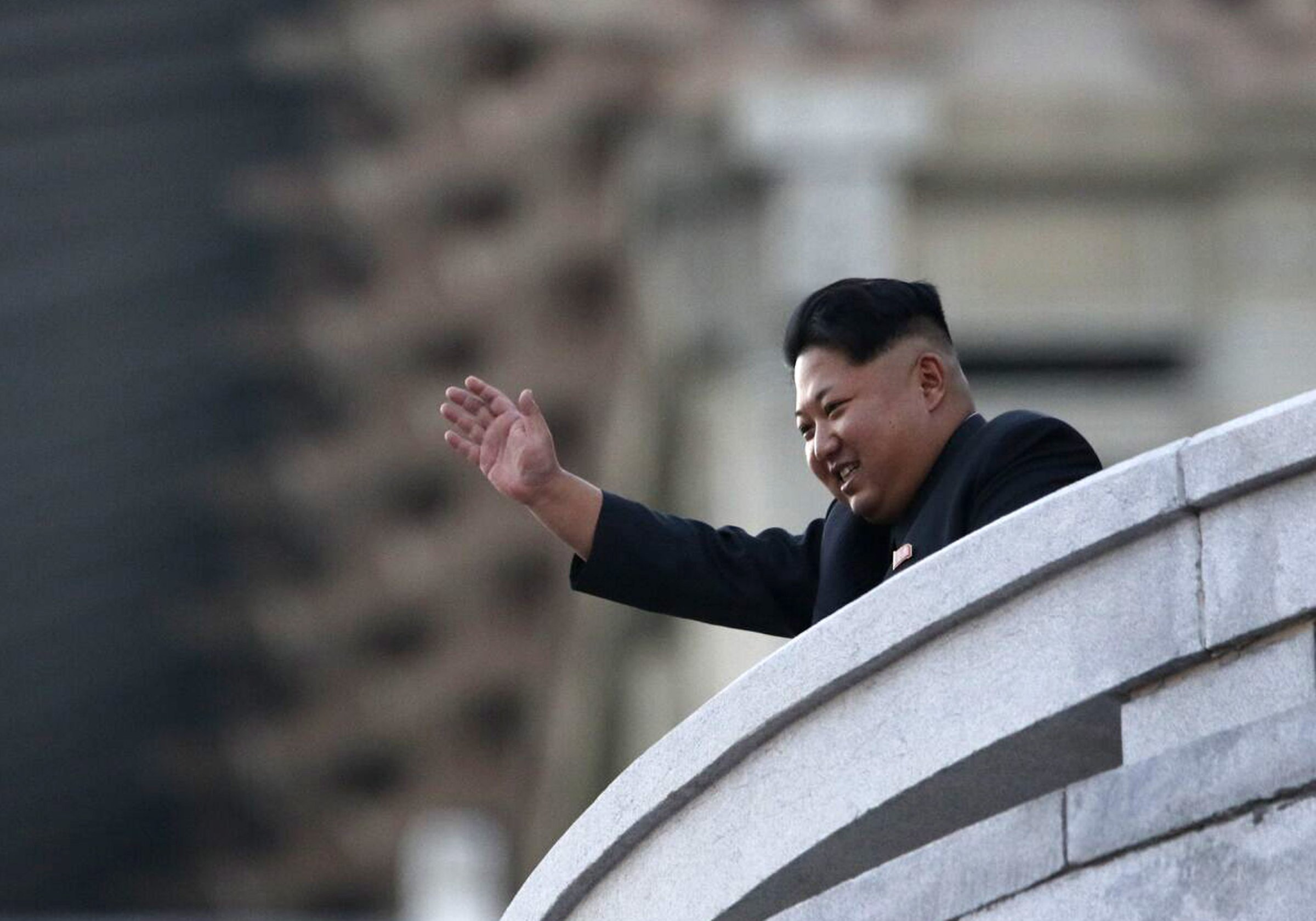PYONGYANG, NORTH KOREA - OCTOBER 10: (CHINA OUT) North Korea's leader Kim Jong-Un waves from a balcony towards participants of a mass military parade at Kim Il-Sung square to mark the 70th anniversary of its ruling Worker's Party of Korea on October 10, 2015 in Pyongyang, North Korea.  (Photo by ChinaFotoPress/ChinaFotoPress via Getty Images)