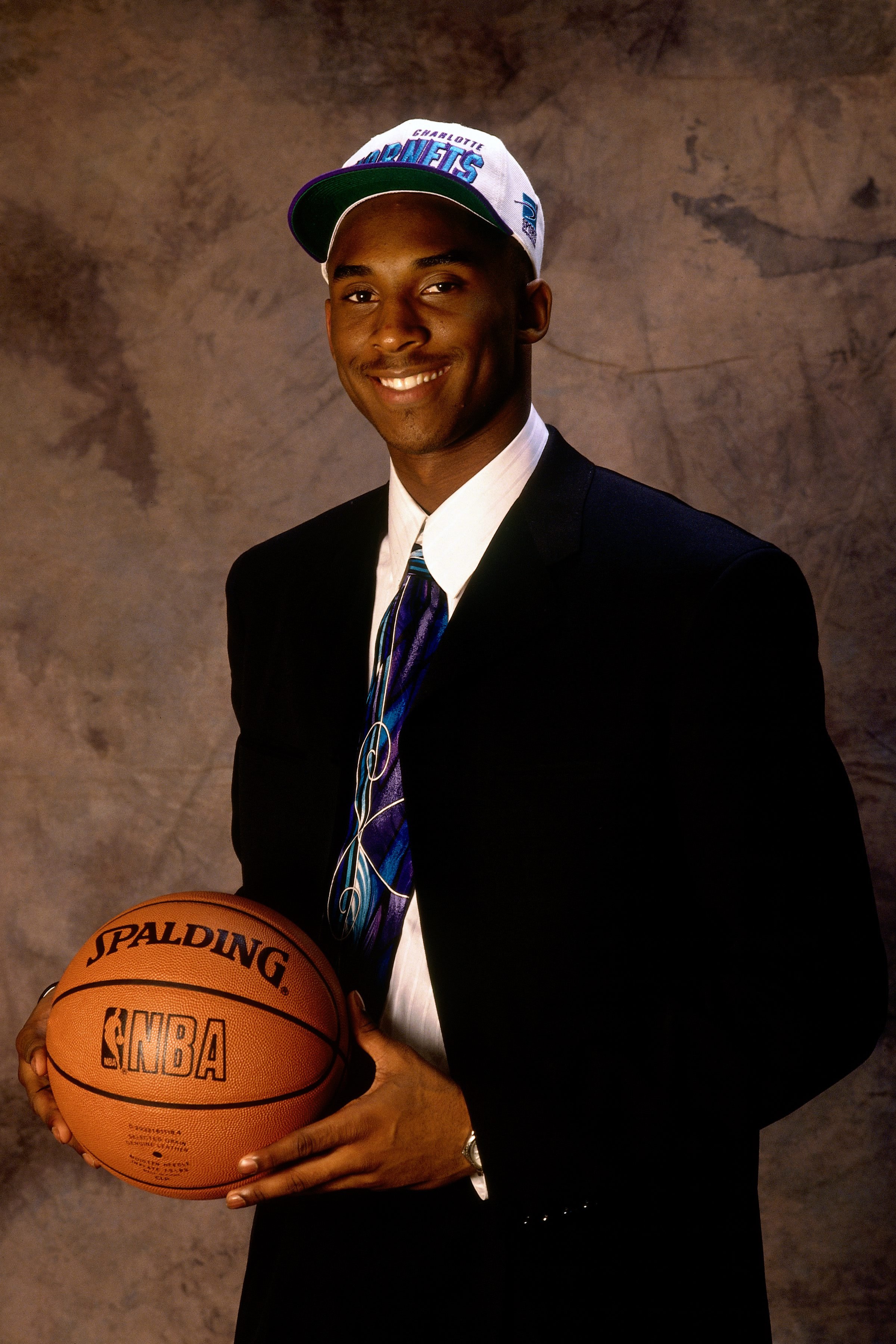 Kobe Bryant poses for a portrait after being selected by the Charlotte Hornets in the first round of the 1996 NBA Draft at Madison Square Garden in New York on June 26, 1996. He joined the NBA straight out of high school, and was immediately traded to the Lakers in a previously-agreed deal between the two teams.