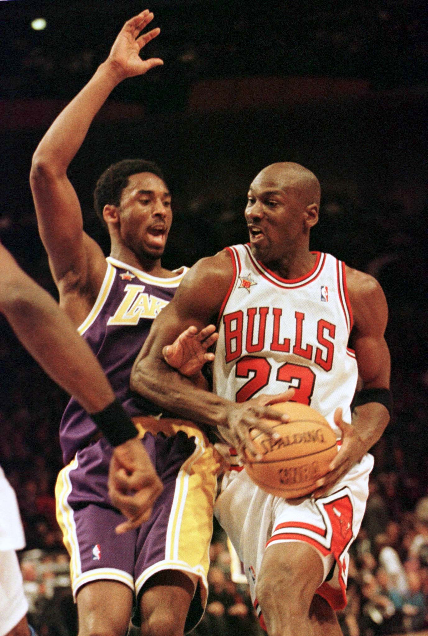Chicago Bulls Michael Jordan, (R) playing for the Eastern Conference, moves past Los Angeles Lakers Kobe Bryant of the Western Division, in the second half of the NBA All-Star game at Madison Square Garden in New York February 8. The 19-year-old Bryant has been called "the next Jordan" for his flamboyant and awe-inspiring skills. SPORT NBA - RTRB795
