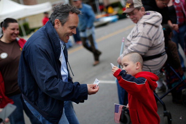 Kentucky Republican senatorial candidate Matt Bevin greets a child at the Fountain Run BBQ Festival while campaigning for the Republican primary May 17, 2014 in Fountain Run, Kentucky.