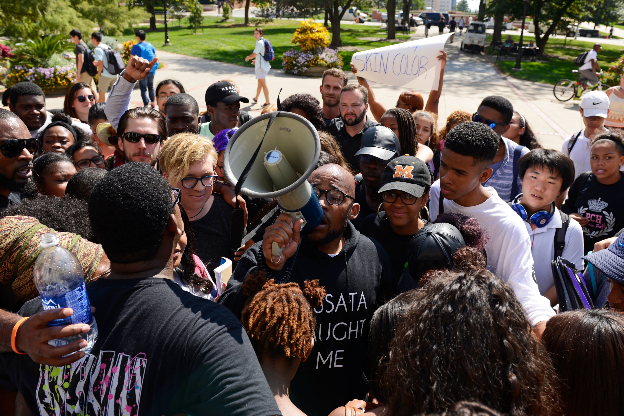 Students gather around graduate student Jonathan Butler for a group hug after marching into Jesse Hall on the University of Missouri campus in Columbia, Mo. on Sept. 24, 2015.