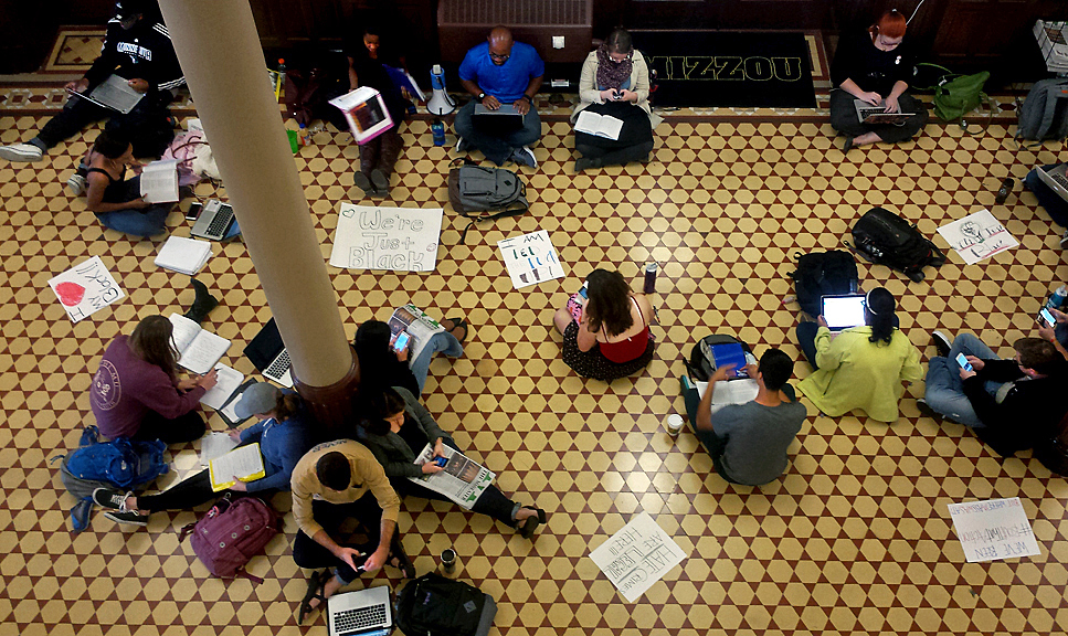 People sit on the floor of Jesse Hall during a Black Lives Matter study hall on Oct. 6, 2015 in Columbia, Mo. The study hall was held after a racial slur interrupted a Legion of Black Collegians Royalty Court rehearsal.