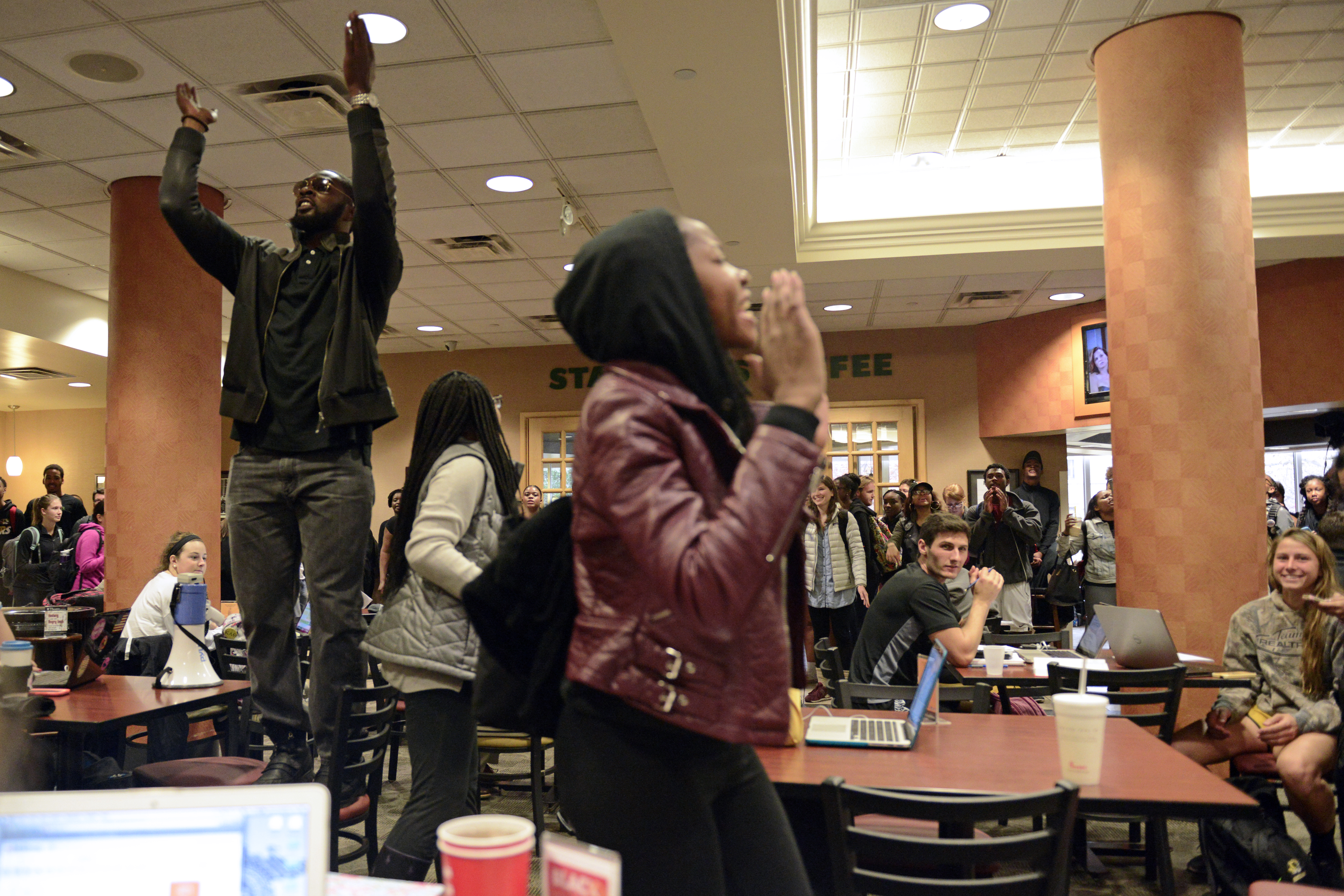 Concerned Student 1950 members chant inside Memorial Union on Nov. 4, 2015. The march took students through various buildings that they viewed as money-making entities for the university.