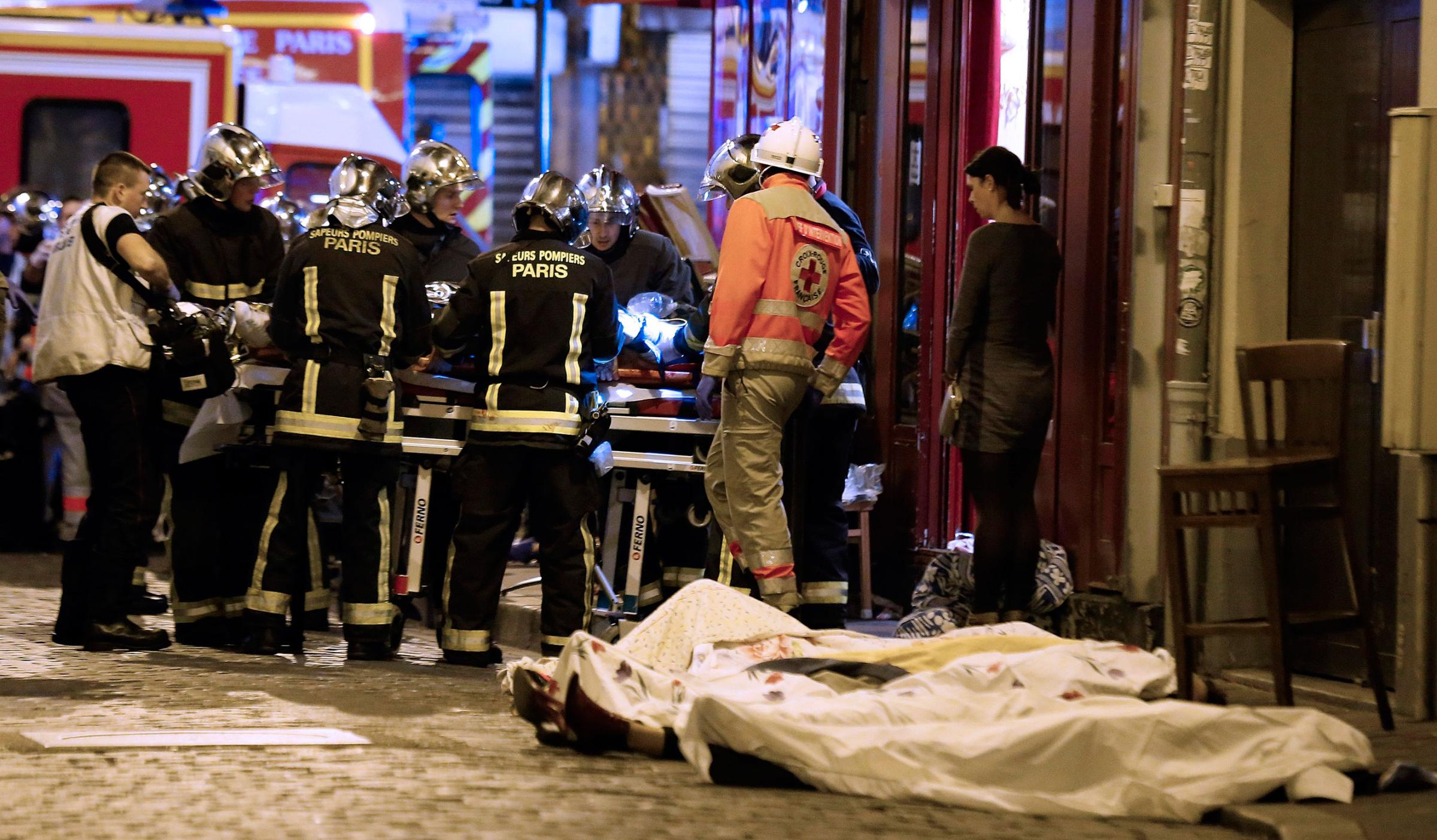 Rescue workers attend to victims of the attacks in the 10th district of Paris on Nov. 13, 2015.