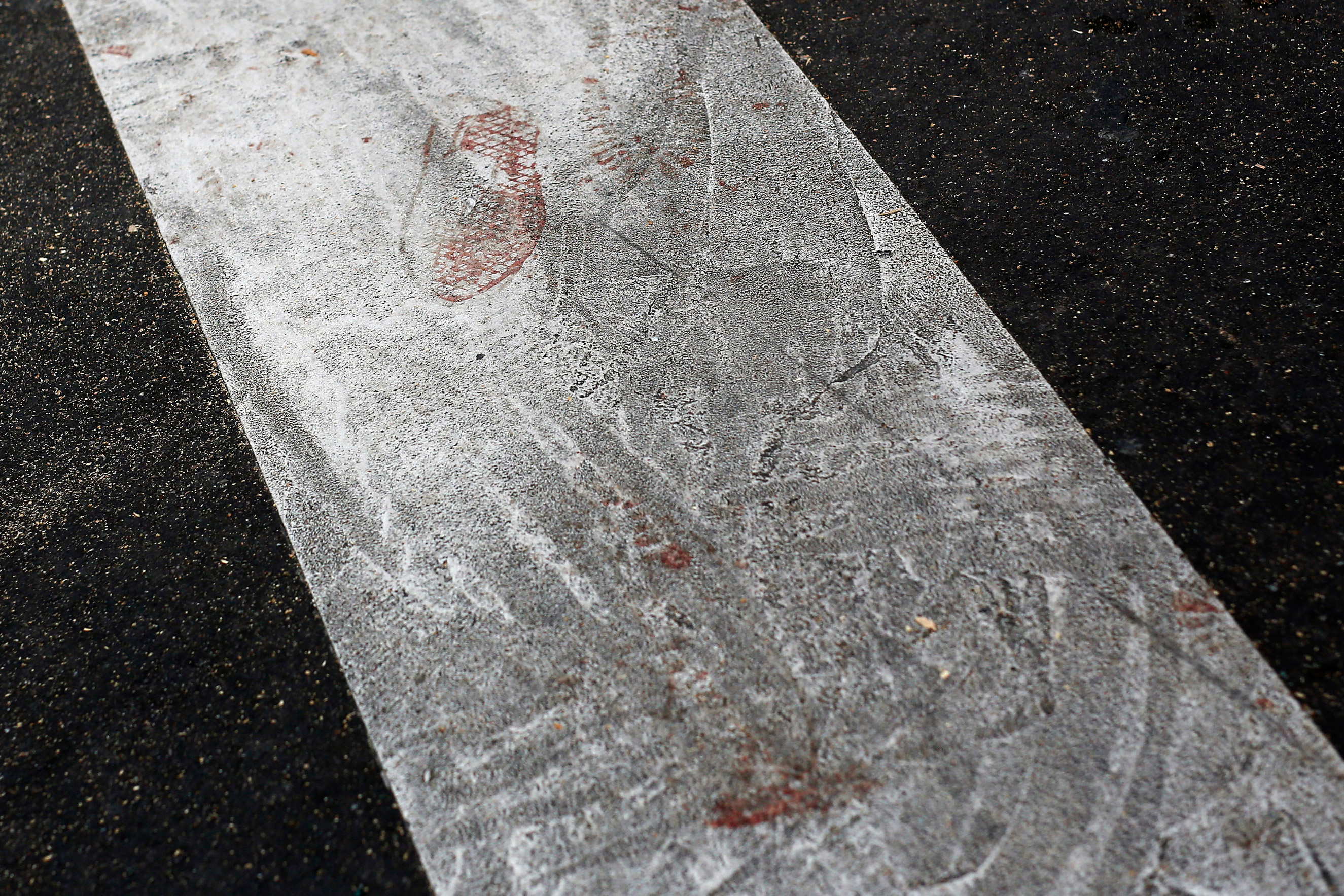 Bloodstained footsteps are visible on the street linking the Carillon cafe and the Petit Cambodge restaurant  in Paris on Nov. 14, 2015.