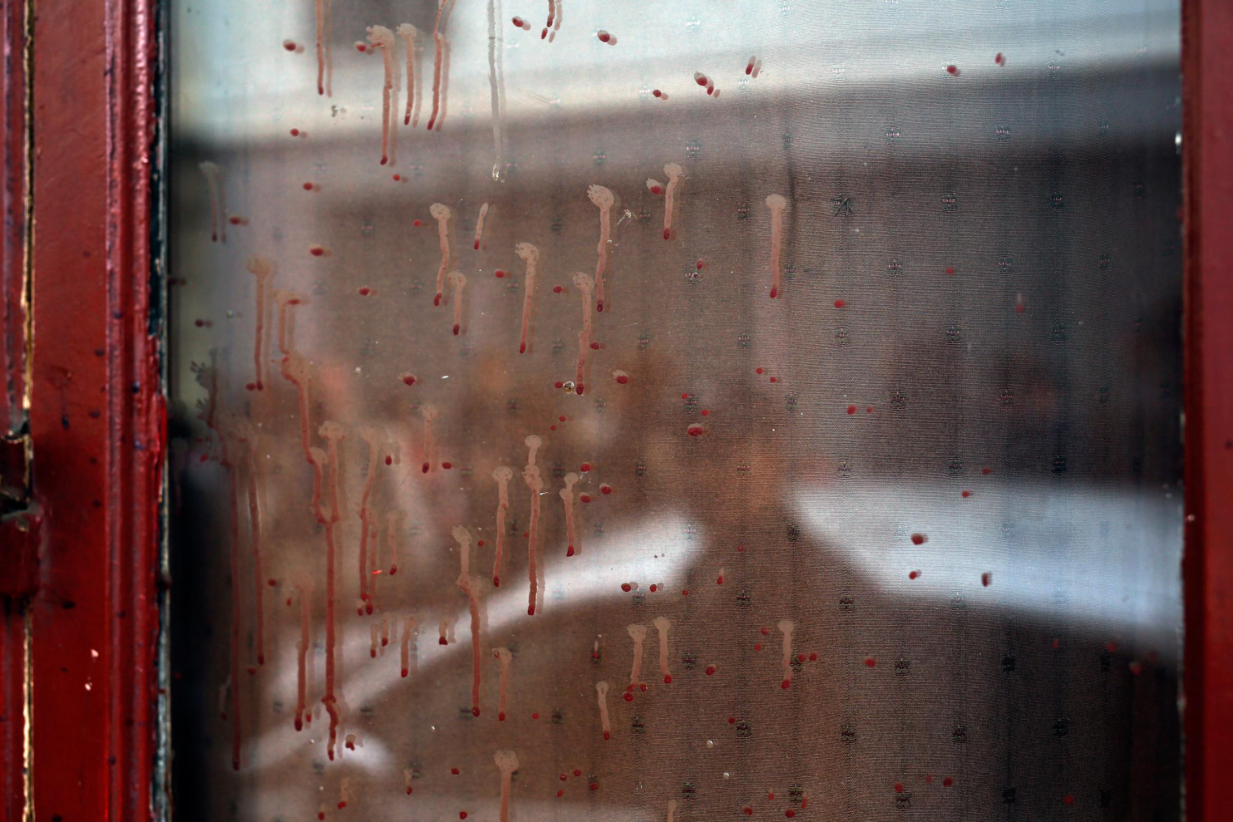 Dried blood on the window of the Carillon cafe in Paris on Nov. 14, 2015.