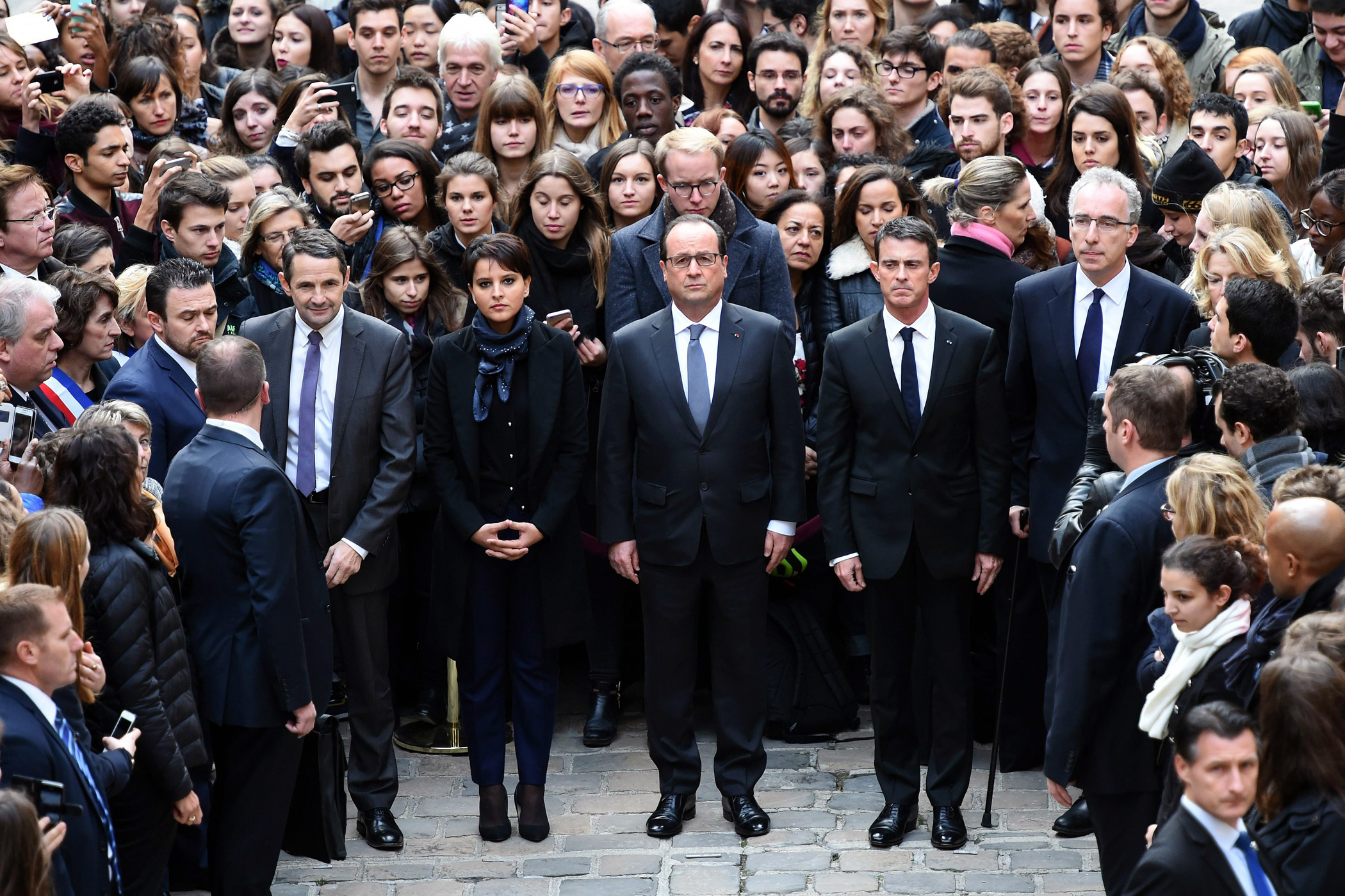 French President Francois Hollande, center, observes a minute of silence for the victims of the Nov. 13 attacks on Paris at the Sorbonne University on Nov. 16, 2015. French Minister for Higher Education and Research Thierry Mandon, center left, French Education Minister Najat Vallaud-Belkacem, and French Prime Minister Manuel Vallse join Hollande.