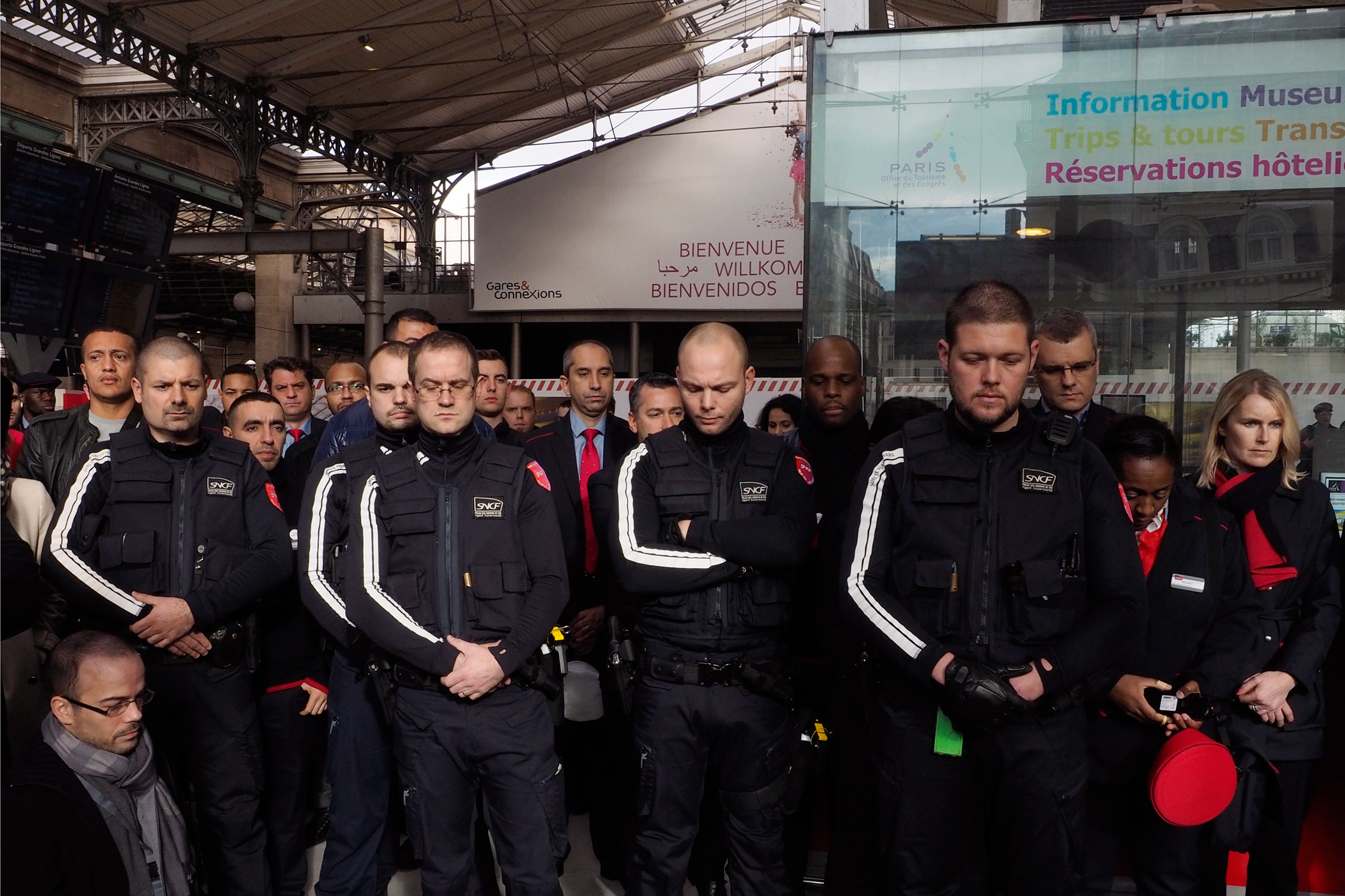 SNCF staff observe a minute of silence for the victims of go the attacks on Paris at Gare du Nord.