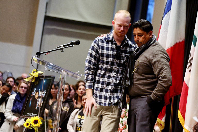 Tim Mraz, boyfriend of Nohemi Gonzalez, is joined by her stepfather Jesse Hernandez during a vigil for Gonzalez, who was killed during the attacks in Paris.