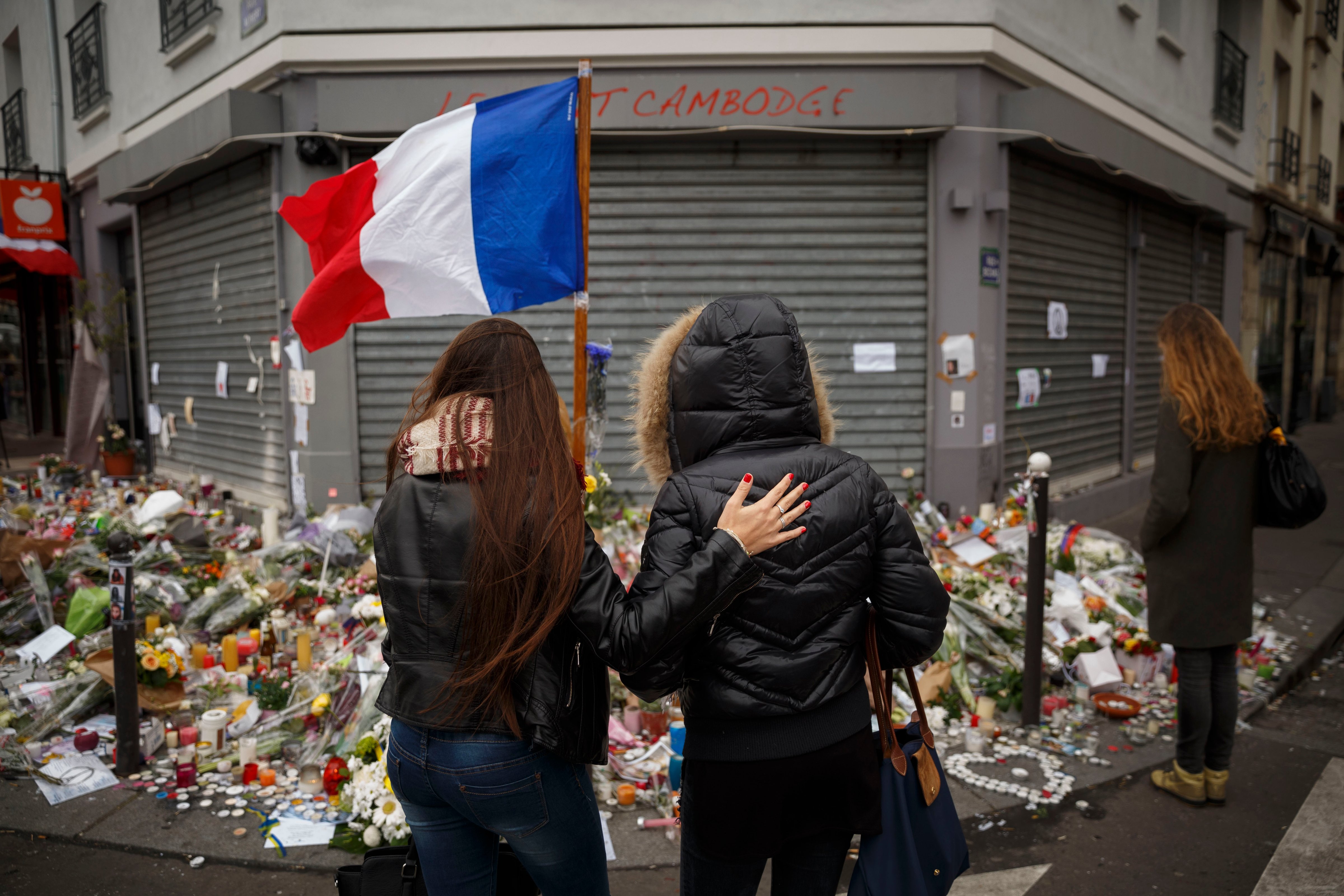 Two women stand outside the Petit Cambodge restaurant, a site of last Friday's attacks, in Paris, on Nov. 17, 2015. (Daniel Ochoa de Olza—AP)