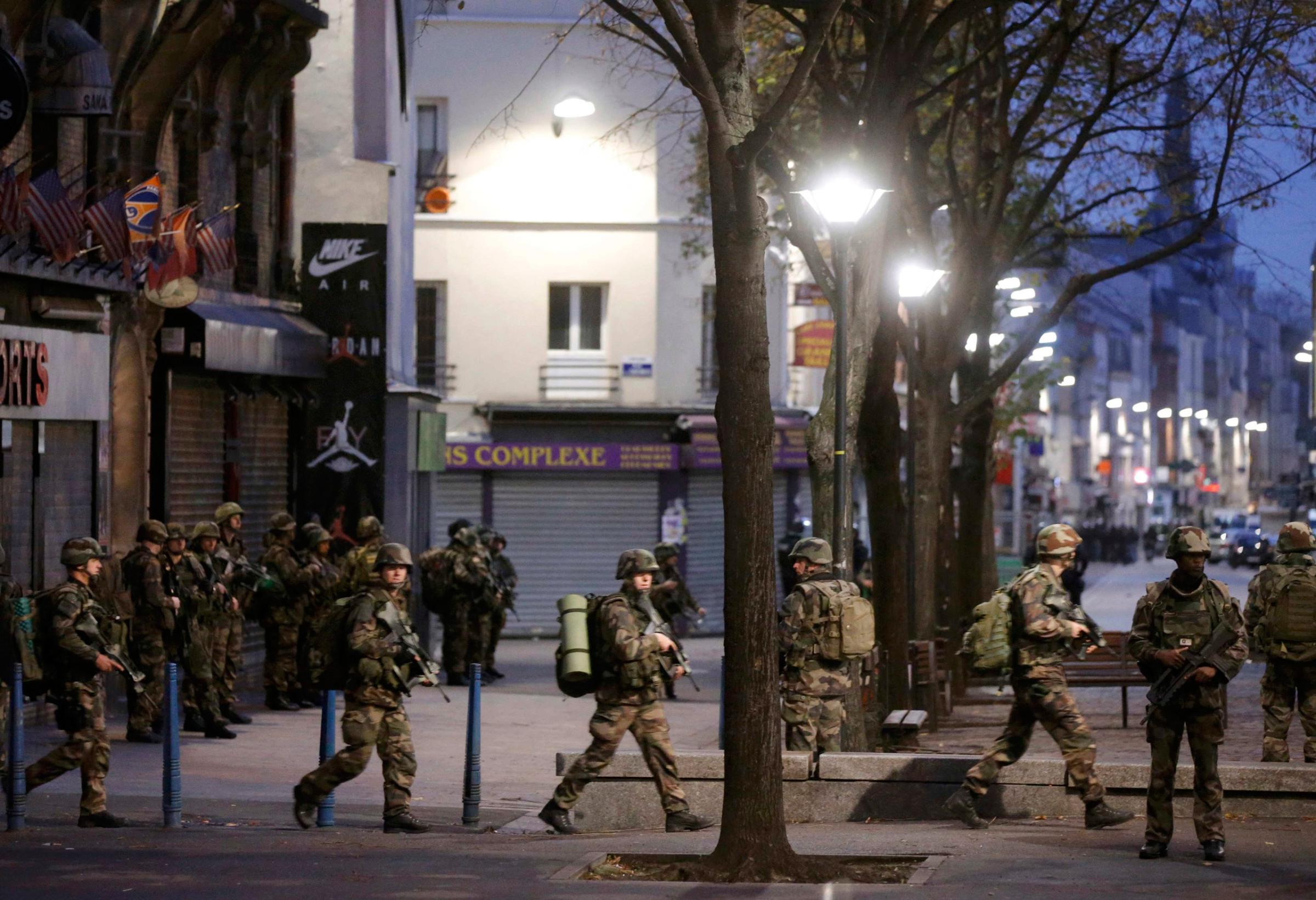 French soldiers secure the area during an operation to catch Paris attack fugitives in Saint-Denis