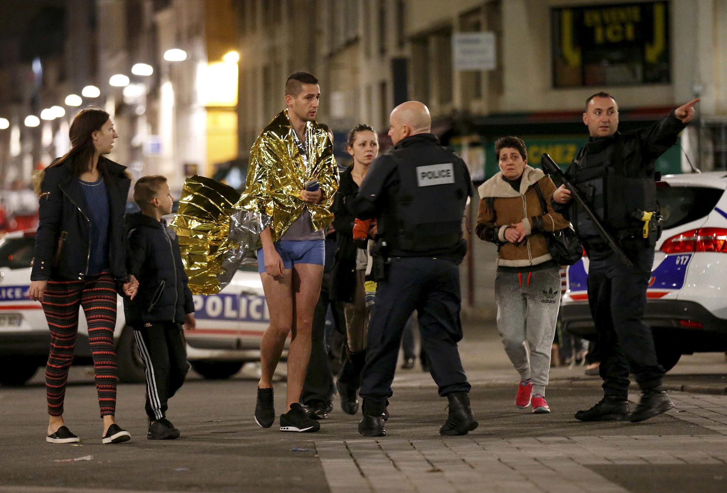 French police evacuate residents during an operation to catch Paris attack fugitives in Saint-Denis