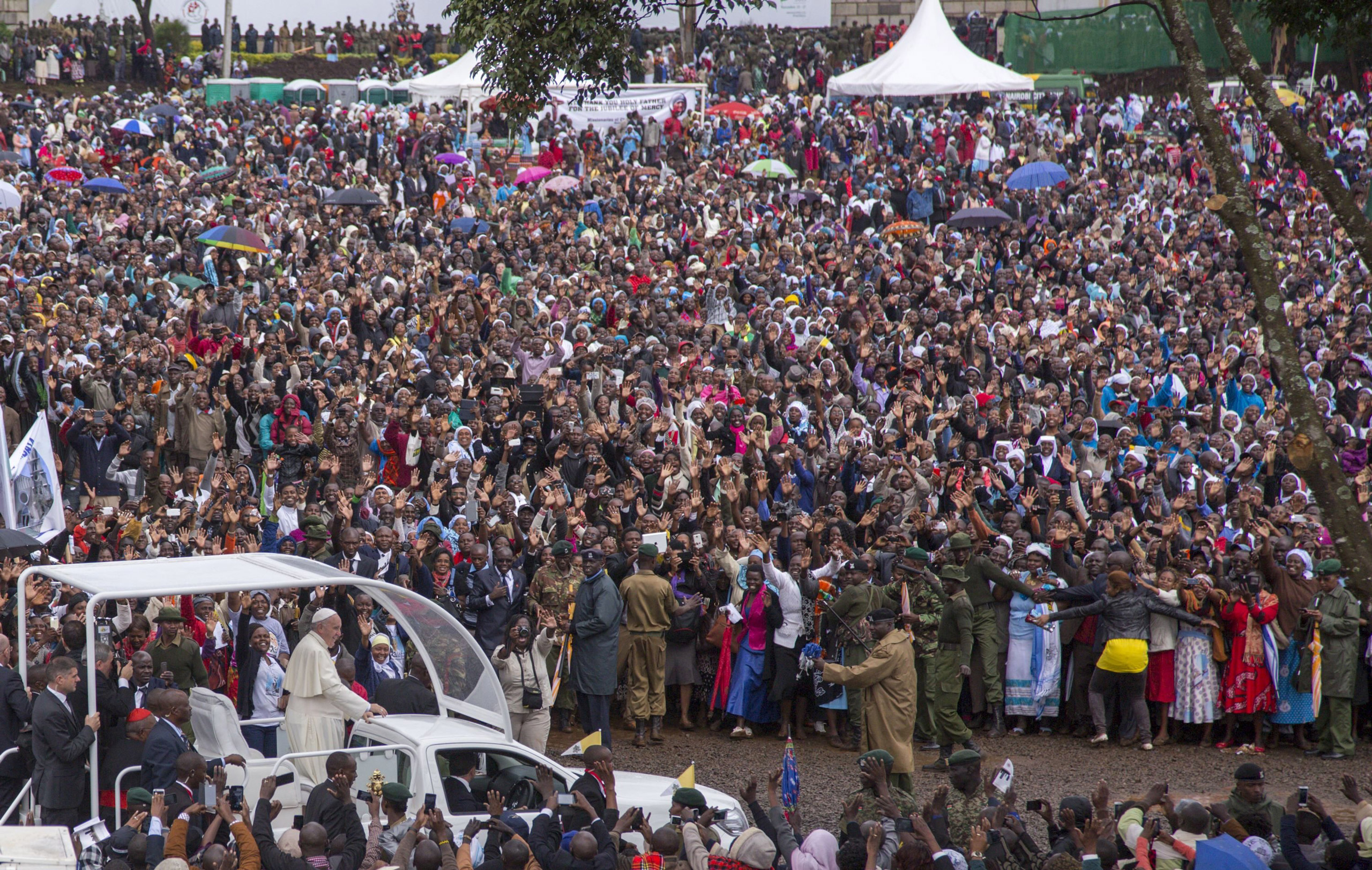 Pope Francis waves to the crowd as he arrives to deliver an open-air mass at the University of Nairobi on Nov. 26, 2015.