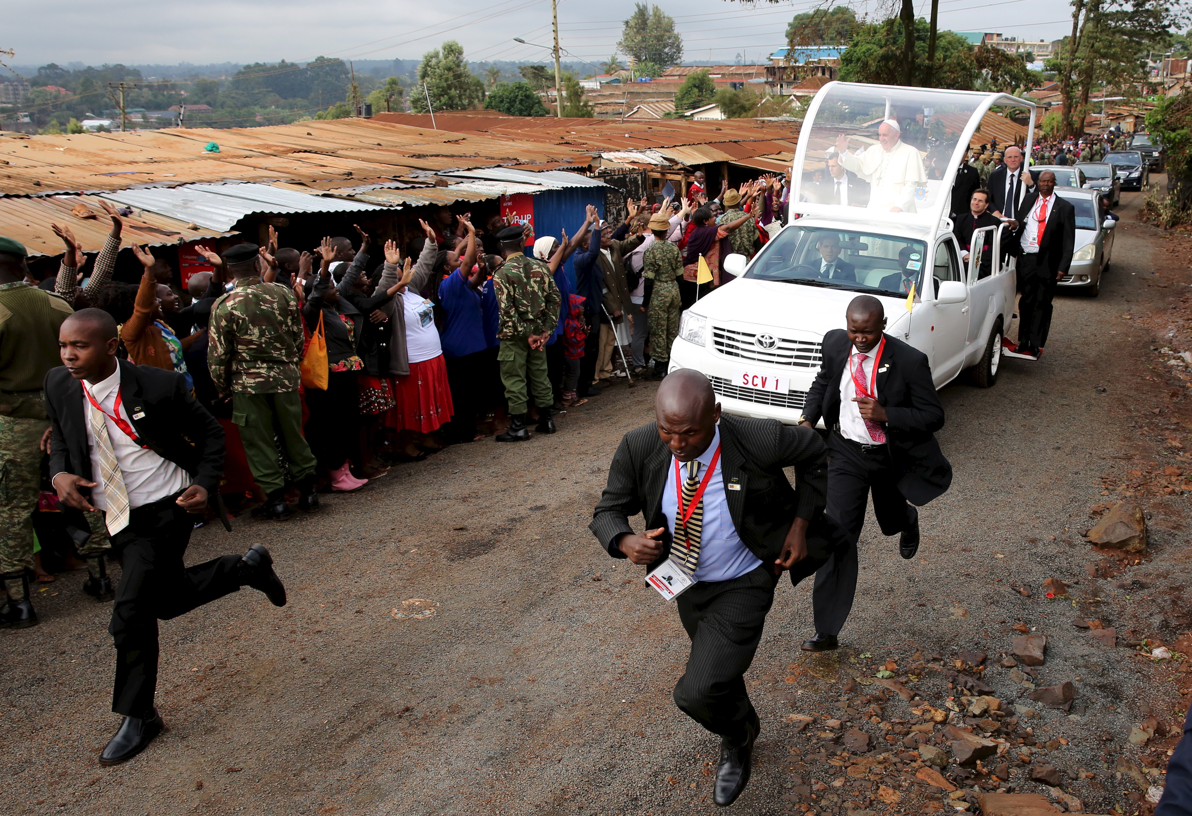 Pope Francis waves as he arrives at the Kangemi slums on the outskirts of Kenya's capital, Nairobi on Nov. 27, 2015.