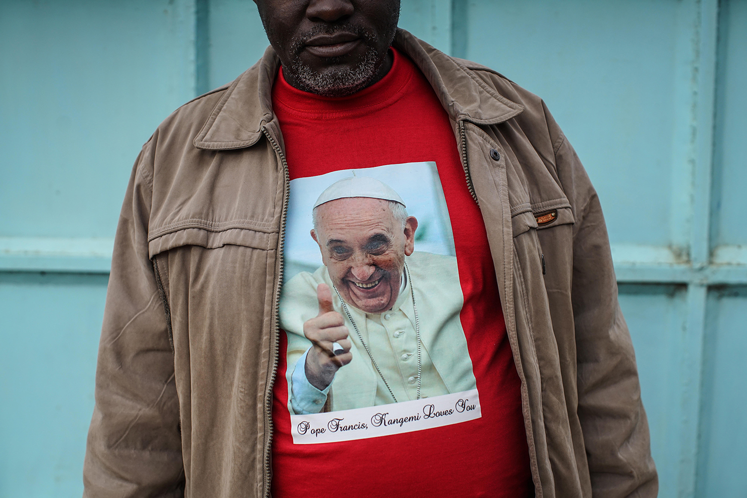 Father Paschal Mwijage of the St. Joseph the Worker Parish in Nairobi's Kangemi slum wears a t-shirt of Pope Francis on Nov. 24, 2015.