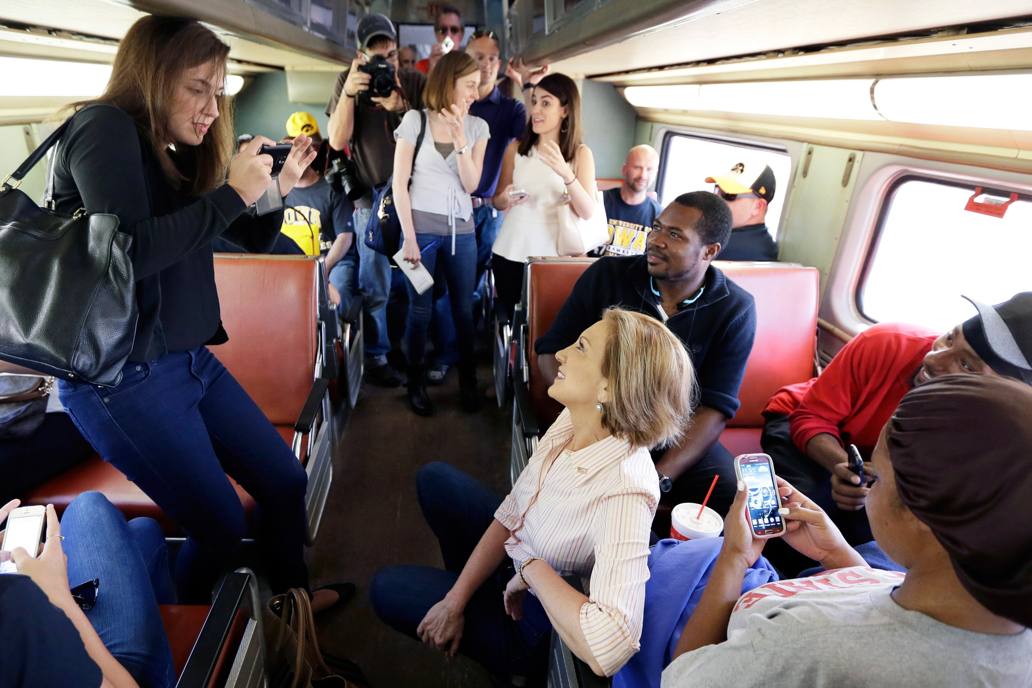 Republican presidential candidate Carly Fiorina, center, rides a train to an event in Iowa City, Iowa on Sept. 26, 2015.