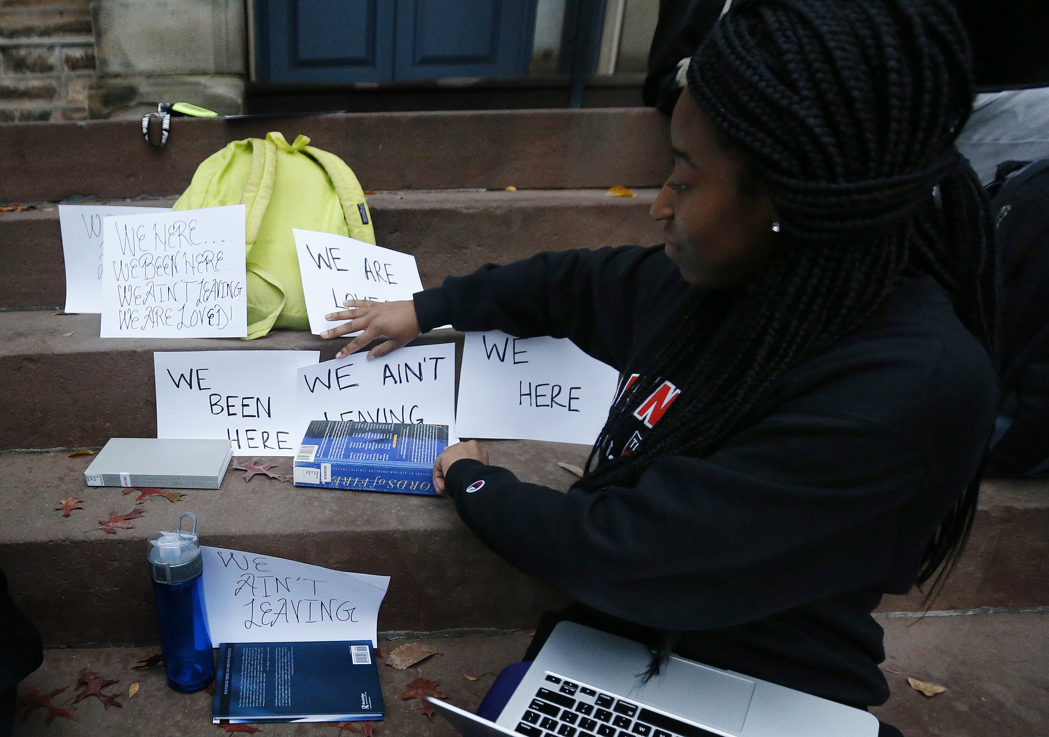 A student shows signs made for a sit-in to demand changes to improve the social and academic experience of black students, at Princeton University in Princeton, N.J. on Nov. 18, 2015. (Julio Cortez—AP)