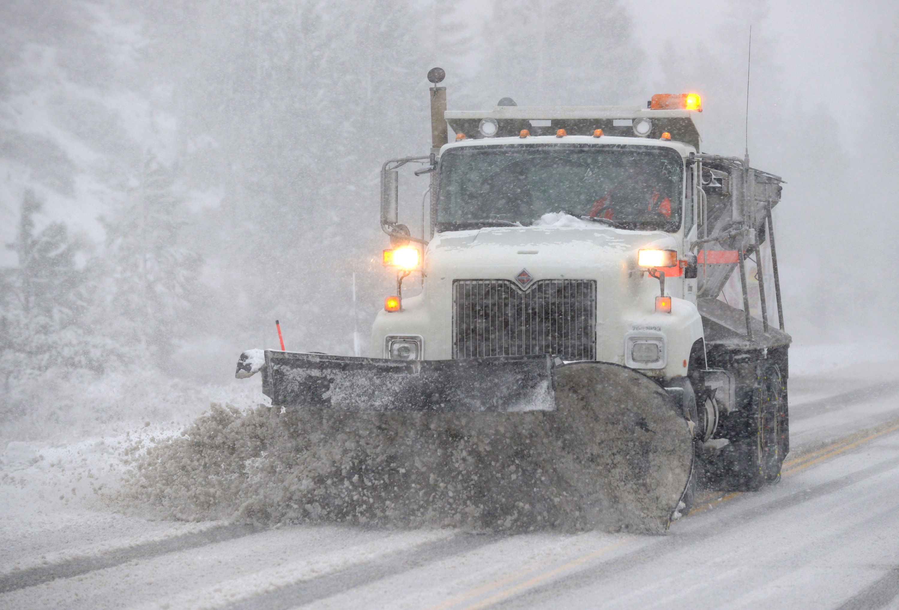 A Caltrans snowplow clears Highway 88 in Woodford, California