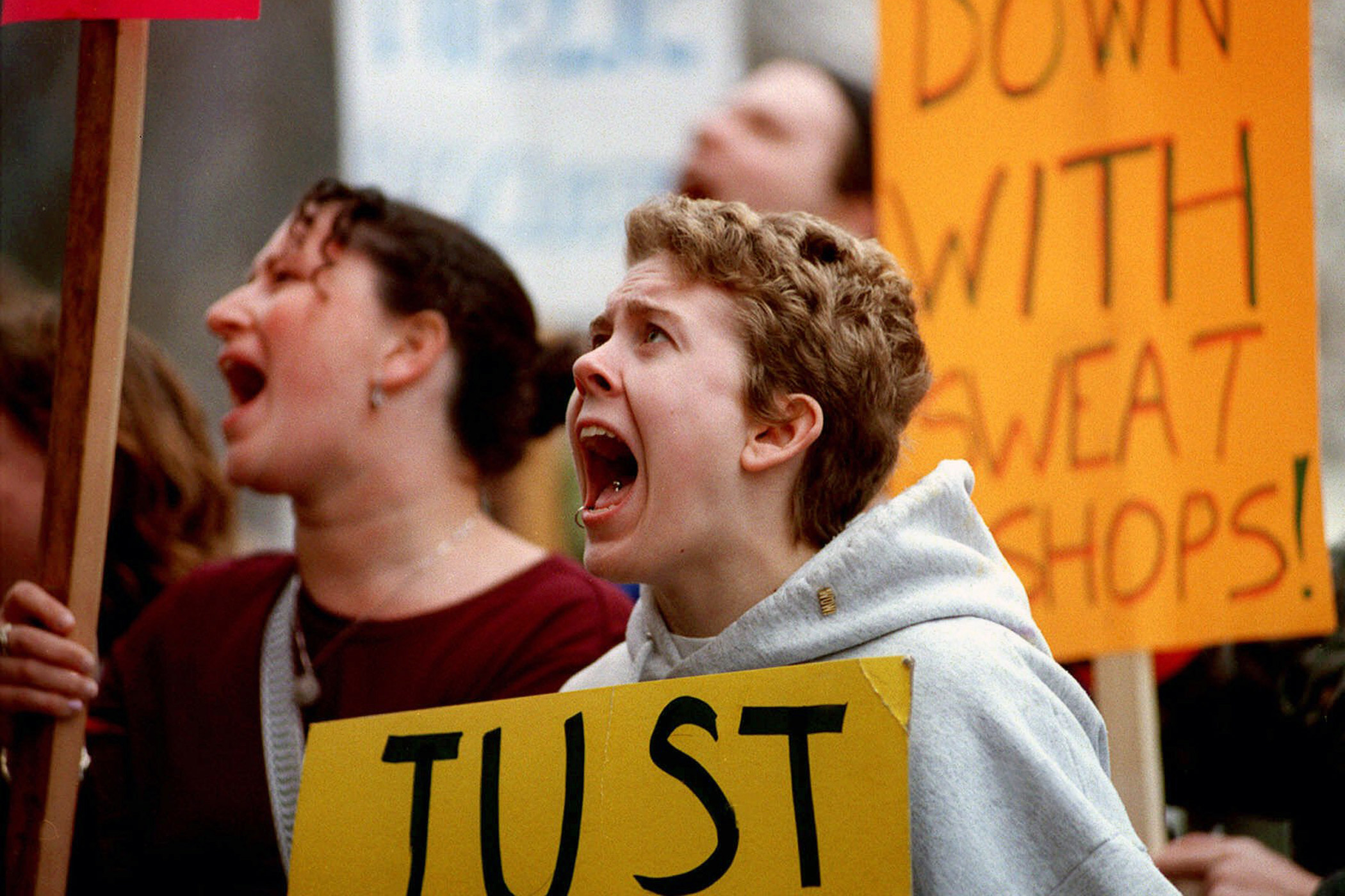 Kerstin Cornell yells outside the office of University of Michigan President Lee Bollinger during a sit-in on March 17, 1999. Students began the sit-in to protest sweatshop conditions in factories that make licensed apparel for the school, which was the nation's leading university in the sales of licensed apparel and other goods. The university established an Anti-Sweatshop Advisory Committee that spring.