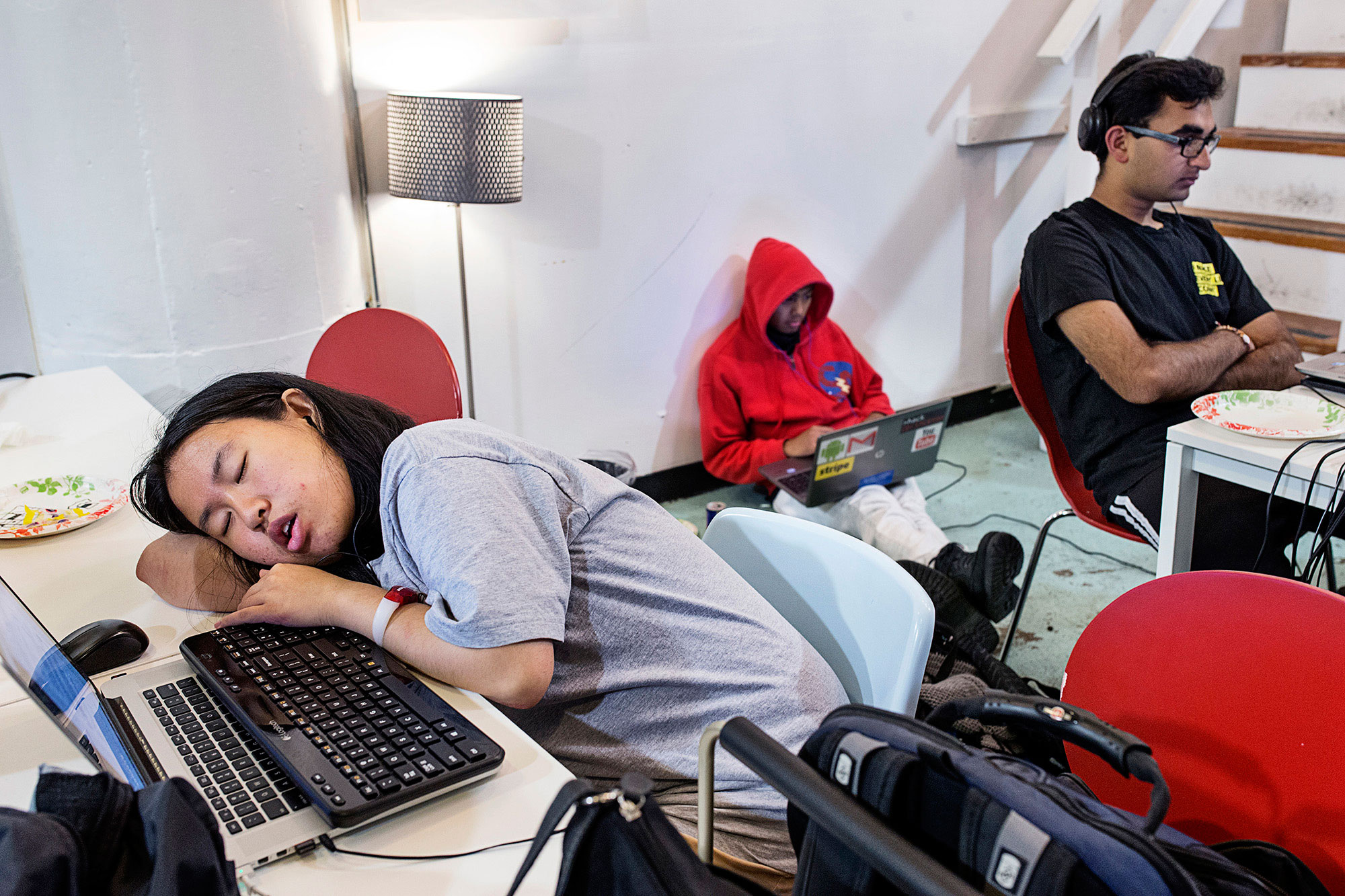 A participant in a hackathon organized by the company Shirts.io takes a nap at her computer in the middle of the night at Citizen Space in San Francisco, Calif., on Saturday, August 16, 2014. From the series,  Wild West Tech.