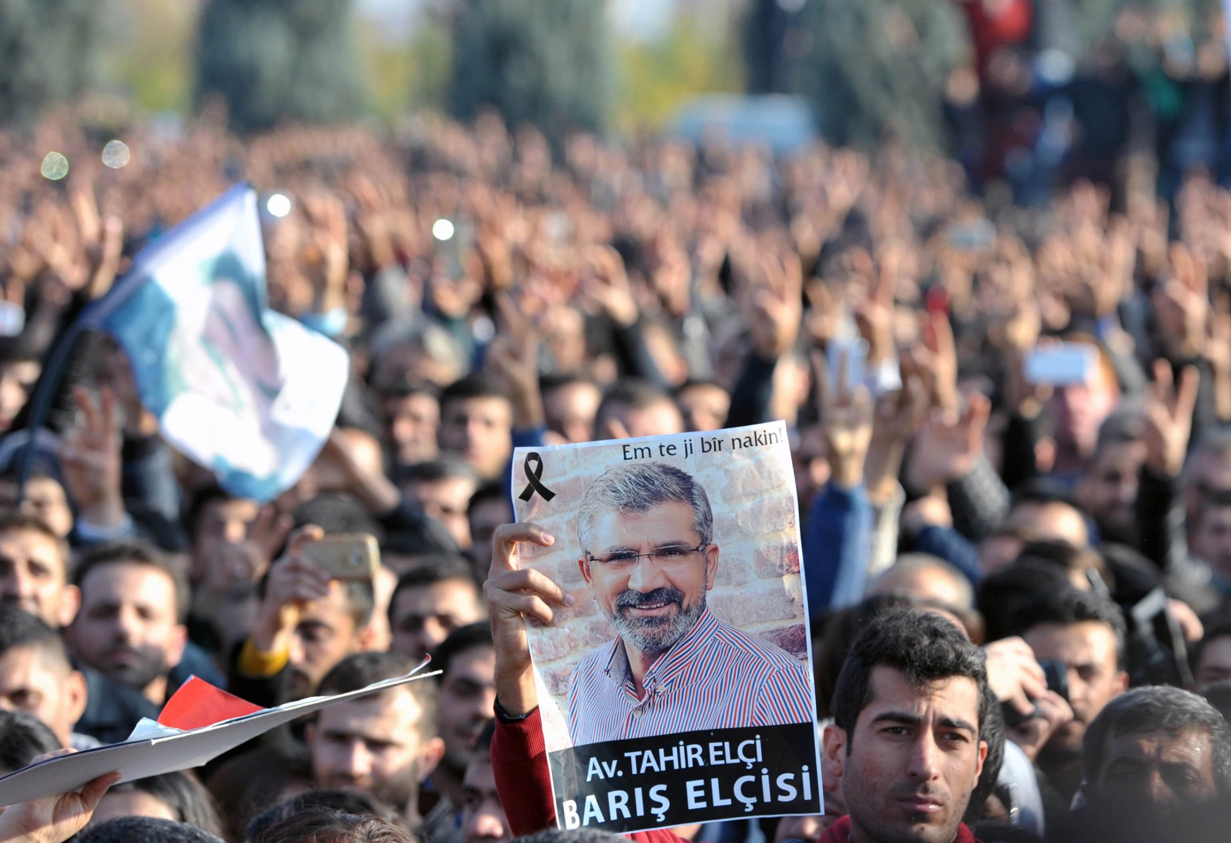 Image #: 41174158 (151129)-- DIARBAKIR, Nov. 29, 2015 (Xinhua) -- A man holds a portrait of Tahir Elci during a mourning ceremony for Tahir Elci, head of the Bar Association in Diyarbakir, who was killed on Nov, 28 in Turkey's southeastern Diyarbakir province on Nov. 29, 2015. An unknown gunman opened fire at Tahir Elci's gathering in a press meeting in Diyarbakir on Saturday, killing Elci and one policeman at the scene. (Xinhua/Mert Macit)(azp) XINHUA /LANDOV