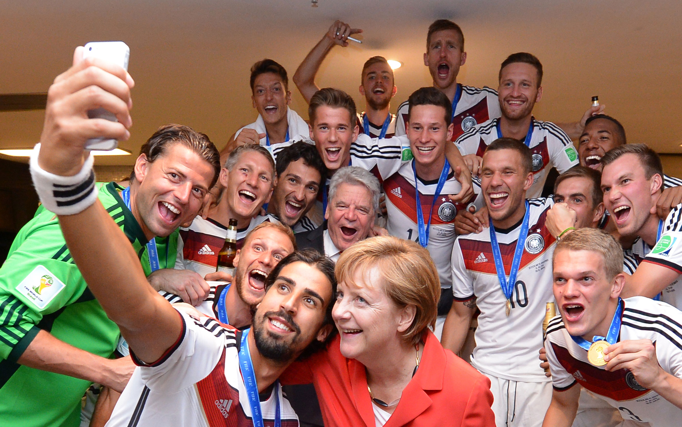 Chancellor Angela Merkel and German President Joachim Gauck celebrate with the players in the Germany dressing room after the 2014 FIFA World Cup Brazil Final match between Germany and Argentina at Maracana on July 13, 2014 in Rio de Janeiro.