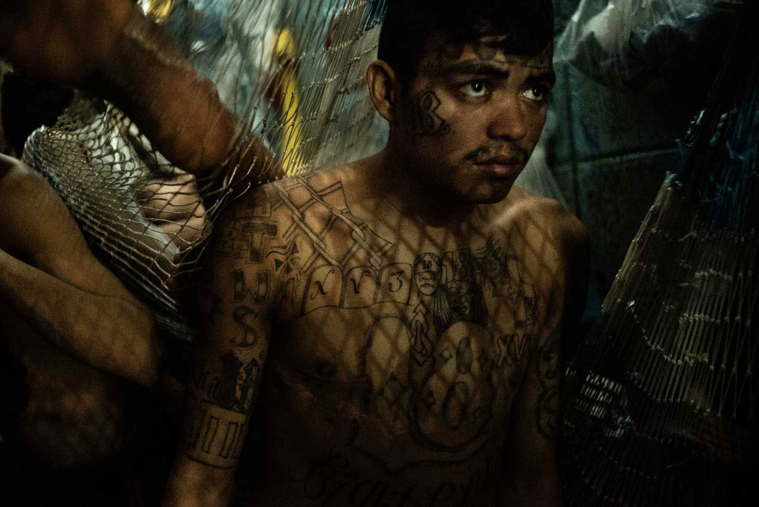 A cell inmate in the district of Soyapango, municipality in San Salvador, where police conducted a night raid in search of Mara Salvatrucha gang’s members. Alleged gang members are handcuffed, identified, and then put into the barltolina, an overcrowded temporary cell at police headquarters.