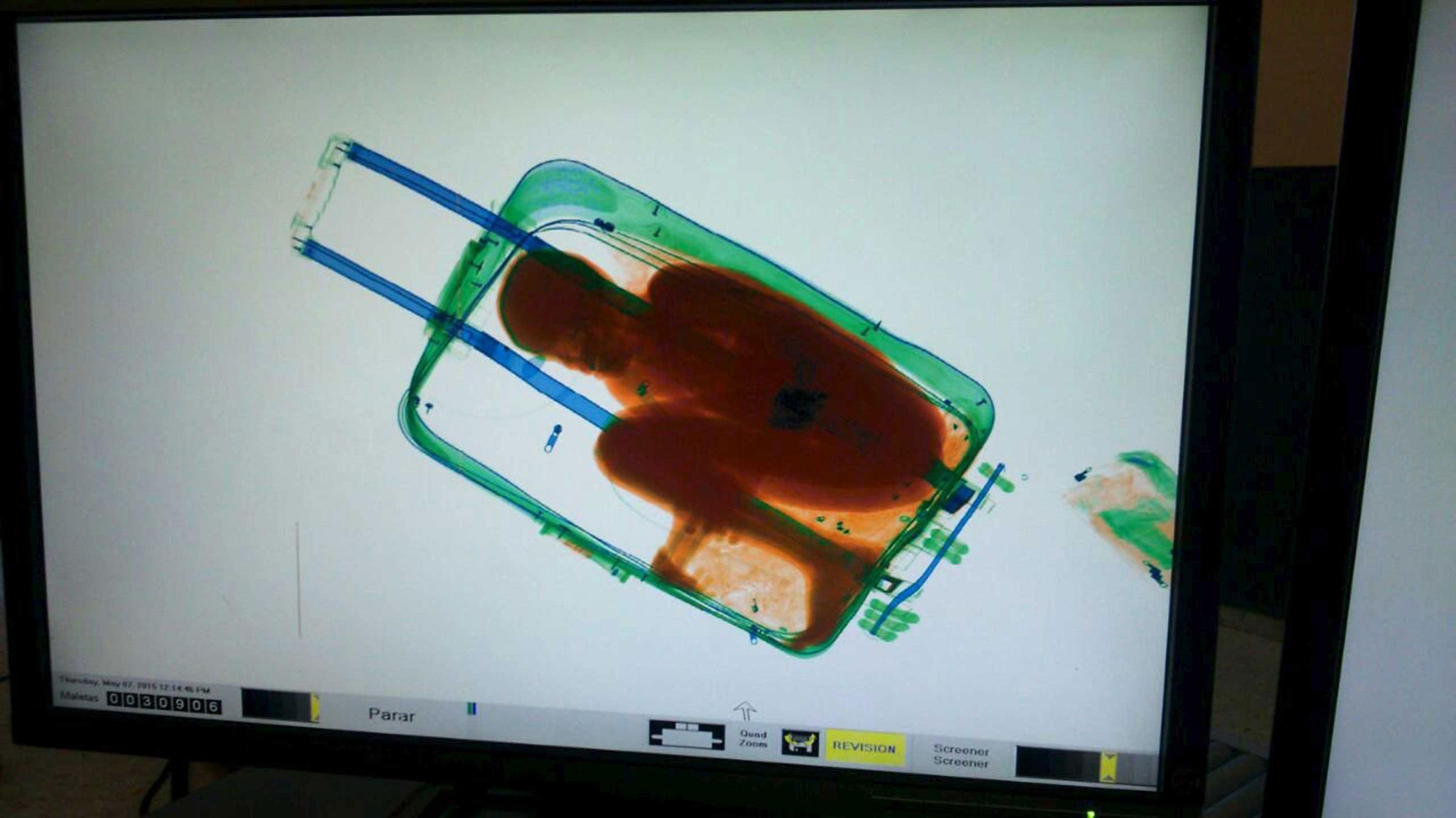 Handout photo of the figure of a boy inside a suitcase is seen on a scanner at the border between Spain's north african enclave Ceuta and Morocco