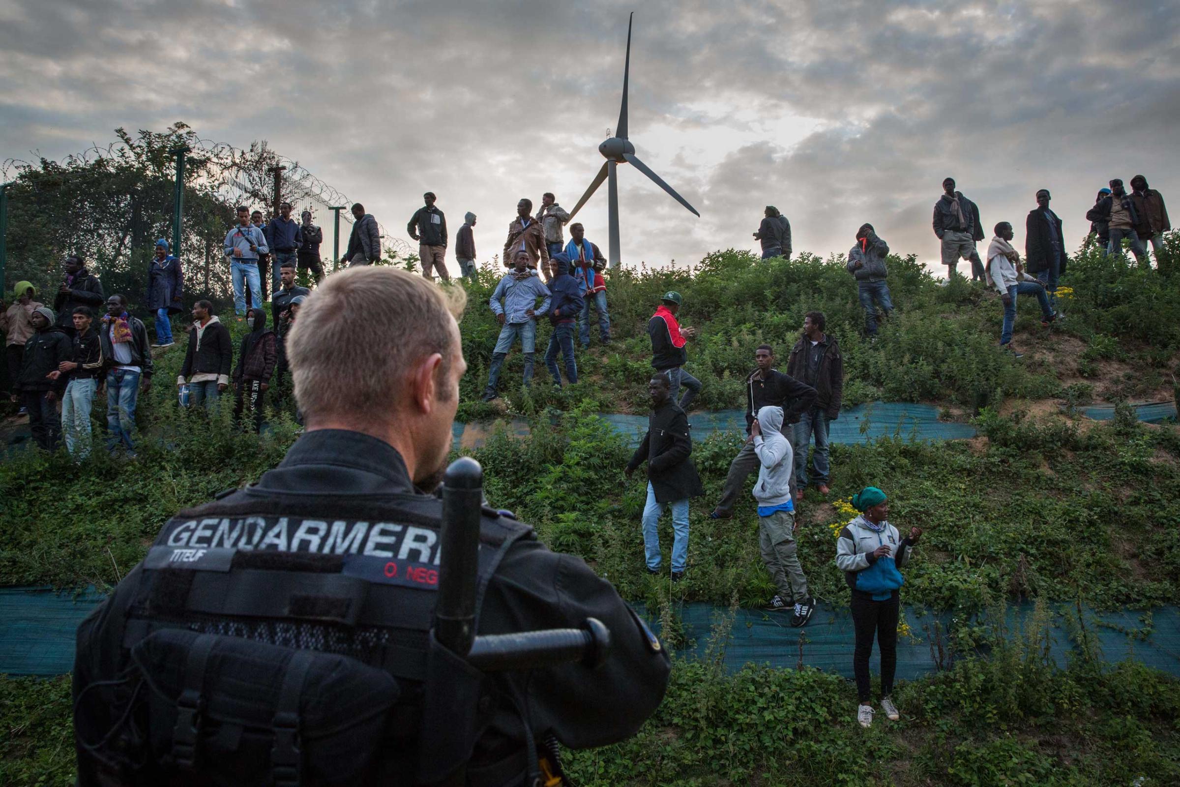 Gendarmerie attempt to prevent people from entering the Eurotunnel terminal in Coquelles in Calais, France. Hundreds of migrants were trying to enter the Channel Tunnel and onto trains heading to the United Kingdom. July 30, 2015