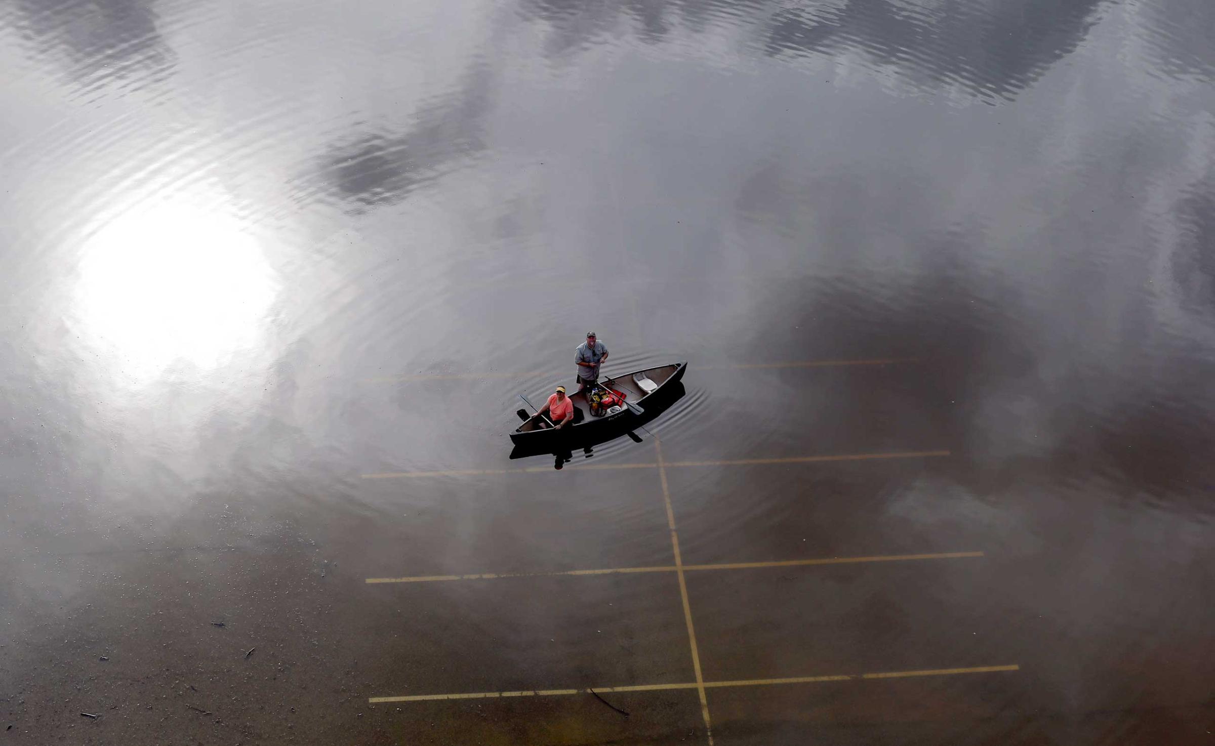 In this aerial photo, people prepare to launch a canoe from a flooded parking lot near Bear Creek Park in Houston, Texas. The Colorado River in Wharton and the Brazos and San Jacinto rivers near Houston are the main focus of concern as floodwaters moved from North and Central Texas downstream toward the Gulf of Mexico. May 30, 2015