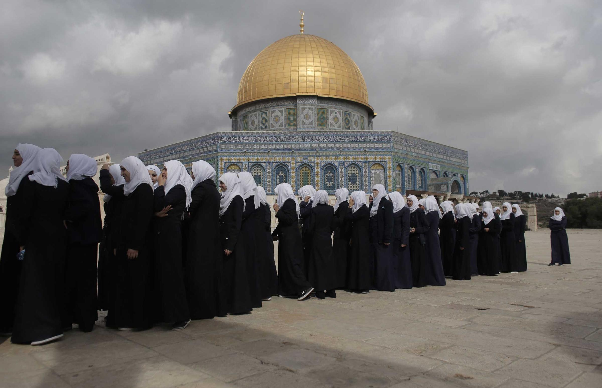 Palestinian school girls walk in line past the Dome of the Rock at the Al-Aqsa mosque compound in Jerusalem's Old City. Israeli Prime Minister Benjamin Netanyahu scrambled to contain inflammatory rhetoric from his government over the holy site, which is sacred to both Muslims and Jews, at the heart of a wave of deadly Palestinian unrest. Oct. 27, 2015