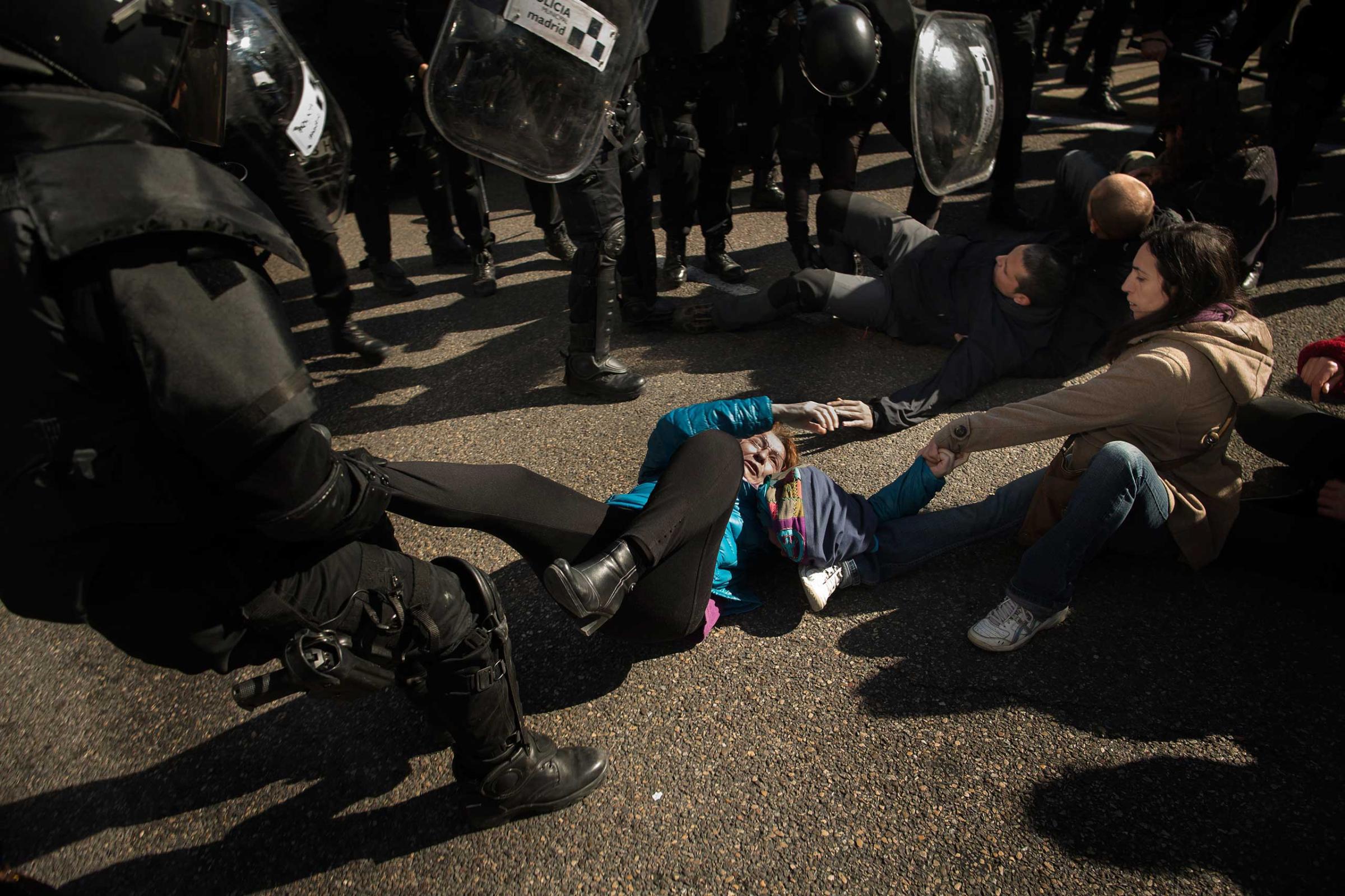 Riot Police remove housing rights activists as they try to stop Luisa Gracia Gonzalez and her family's eviction and the demolition of their house by a forced expropriation in Madrid. Feb. 2015.