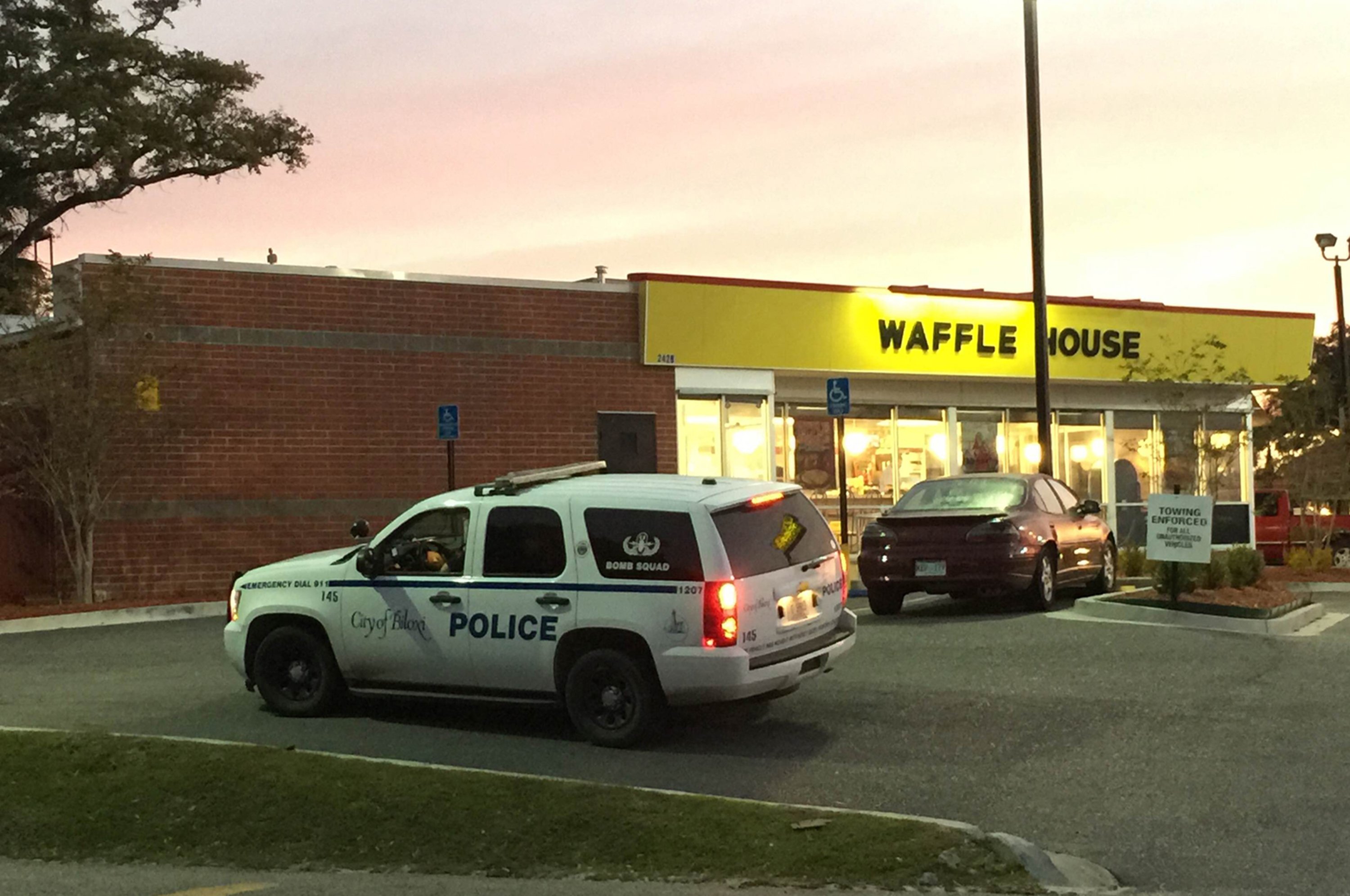 A police vehicle sits outside the Waffle House on U.S. 90 in Biloxi, Miss., after a fatal shooting on Nov. 27, 2015. (Jeff Clark—The Biloxi Sun Herald/TNS/Landov)