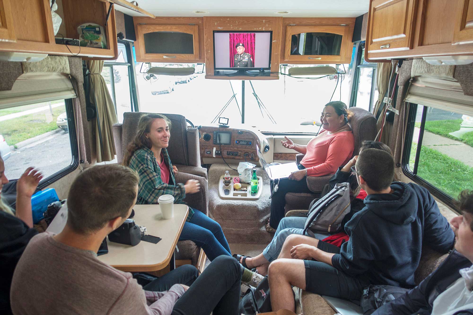 Guest artist Pao Houa Her gives a slideshow of her photographs in the passenger seat of the Winnebago.