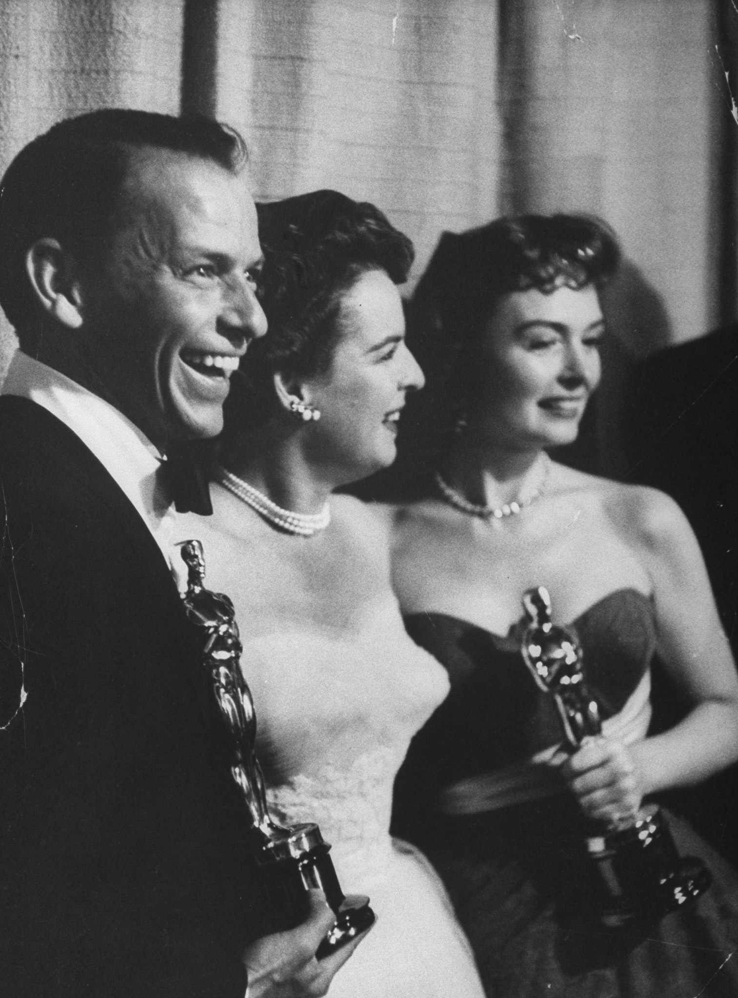 Frank Sinatra and Donna Reed (R) holding Oscars while posing w. presenter, actress Mercedes McCambridge, for Best Supporting Actors in the movie "From Here to Eternity" at the 26th Annual Academy Awards Ceremony, 1954.