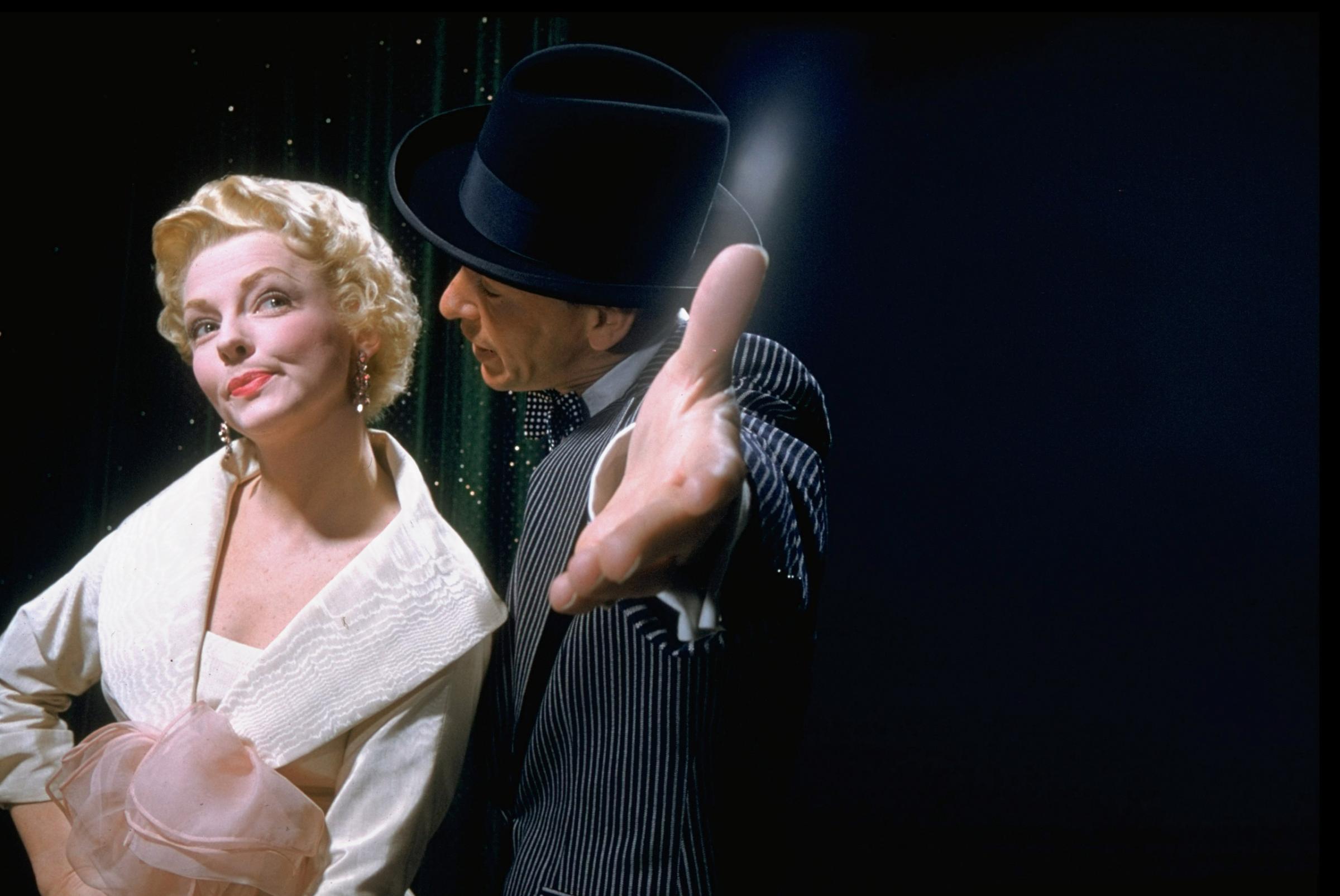 Frank Sinatra singing to Vivian Blaine in scene from film "Guys and Dolls," 1955.