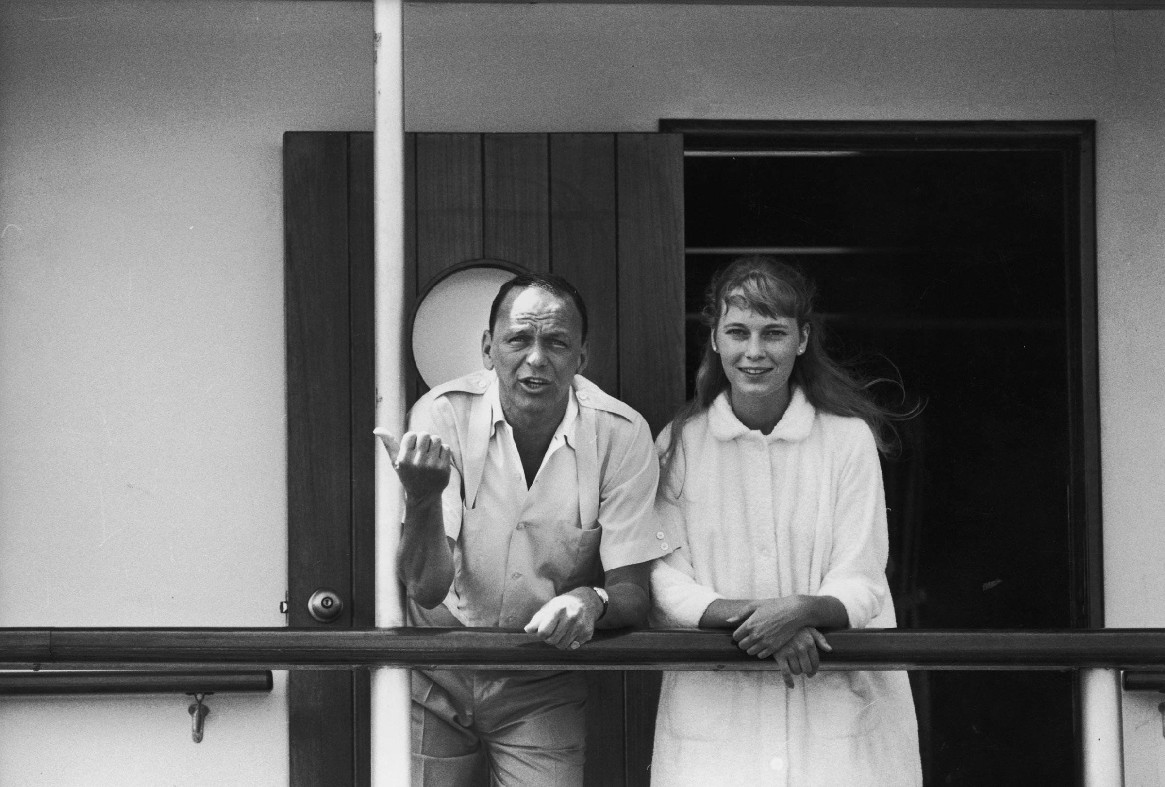 Frank Sinatra with girlfriend Mia Farrow on deck of yacht Southern Breeze, 1965.